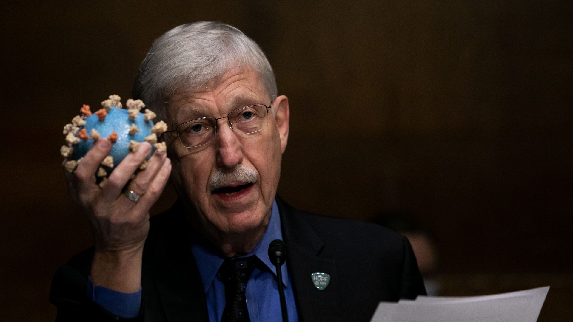 National Health Institute Director Francis S. Collins holds a model of a Coronavirus, as he testifies at a Senate hearing on July 2, 2020 in Washington, DC. 
