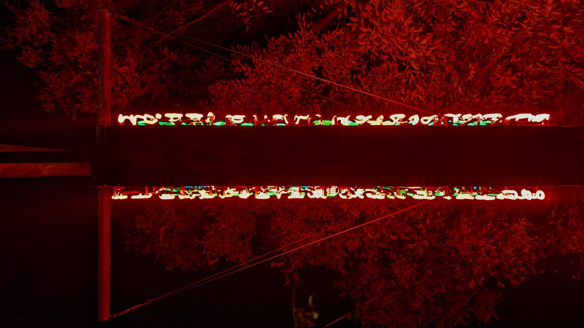 Colors glow on metal beams shaped like a T.