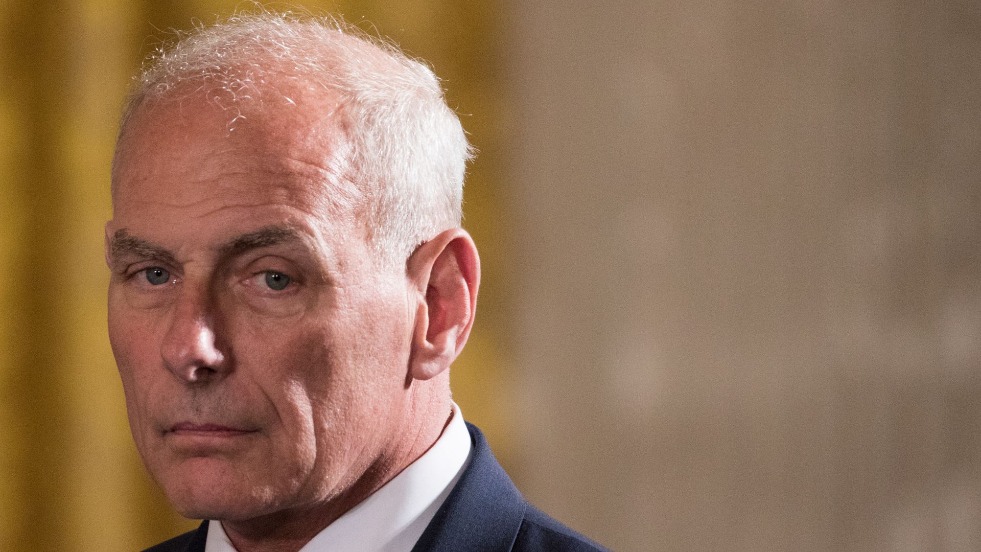 John Kelly in the White House in a suit
