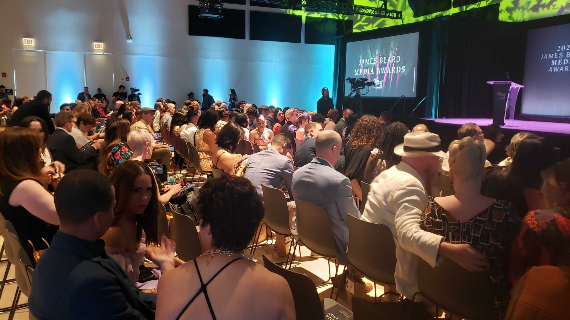 Five rows of people sit in front of the stage at the James Beard Media Awards.