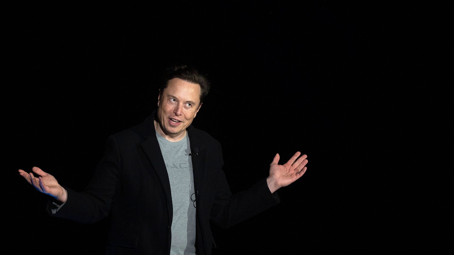 Elon Musk gestures as he speaks during a press conference at SpaceX's Starbase facility.