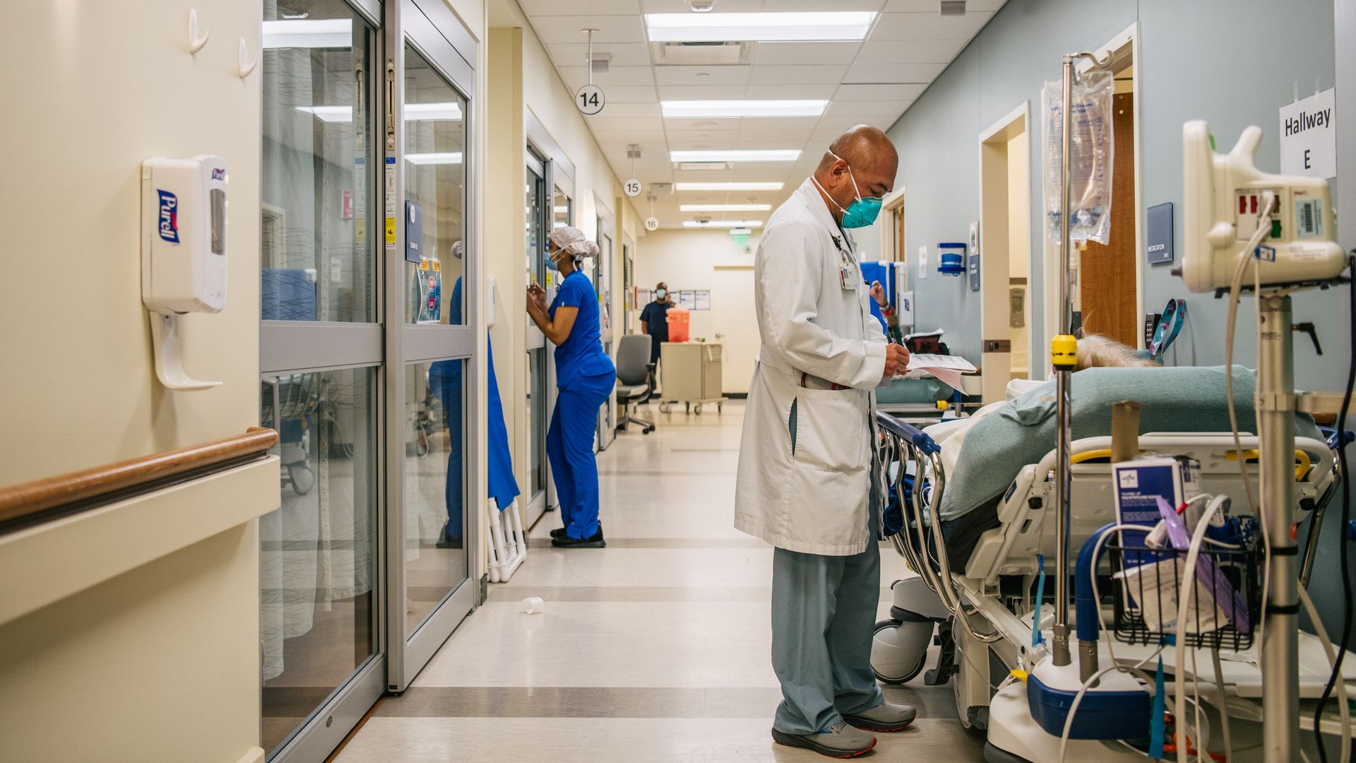 Dr. Michael Nguyen tends to a patient in a hallway at the Houston Methodist The Woodlands Hospital on August 18, 2021 in Houston, Texas