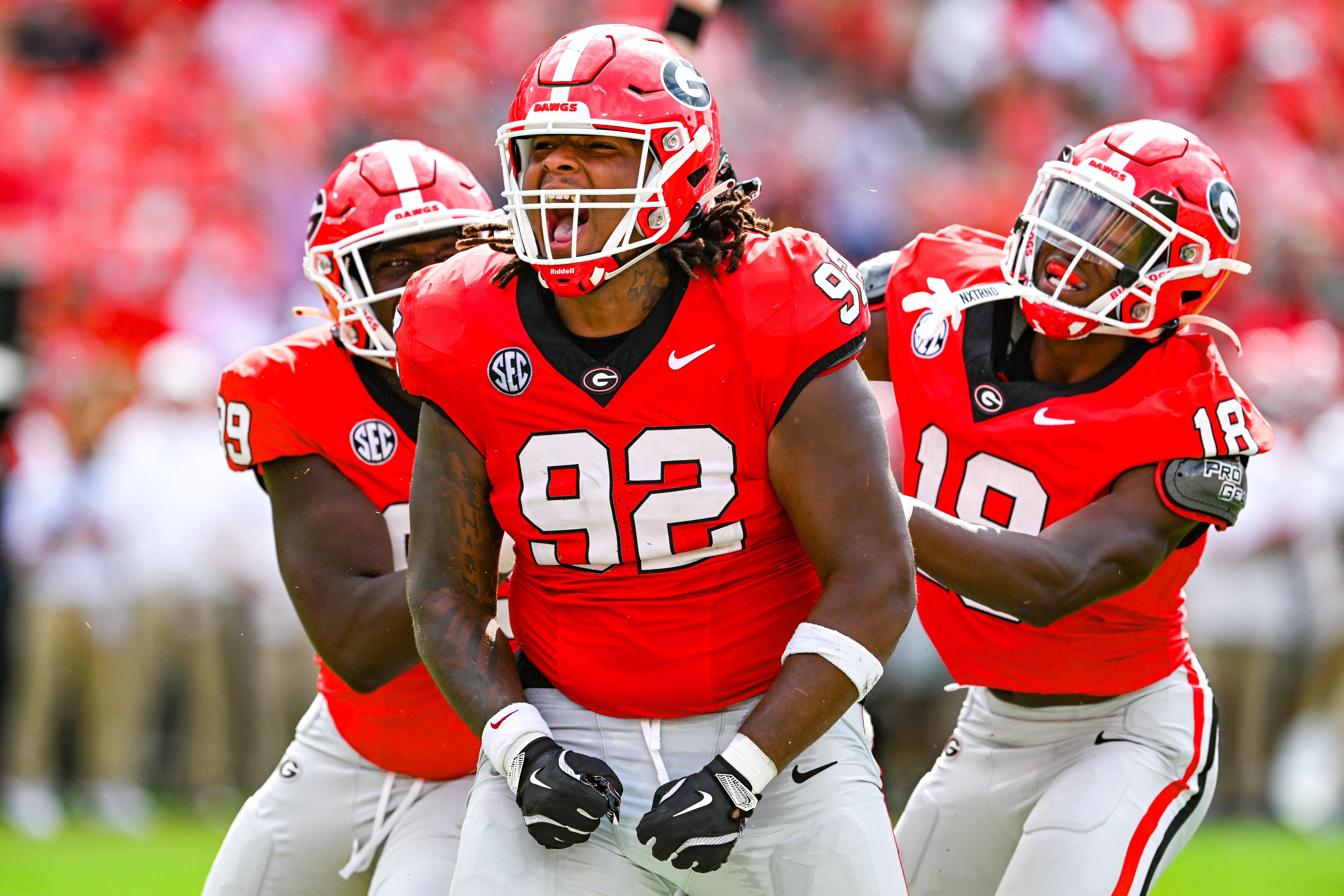 Football payes in red uniforms celebrate during a game