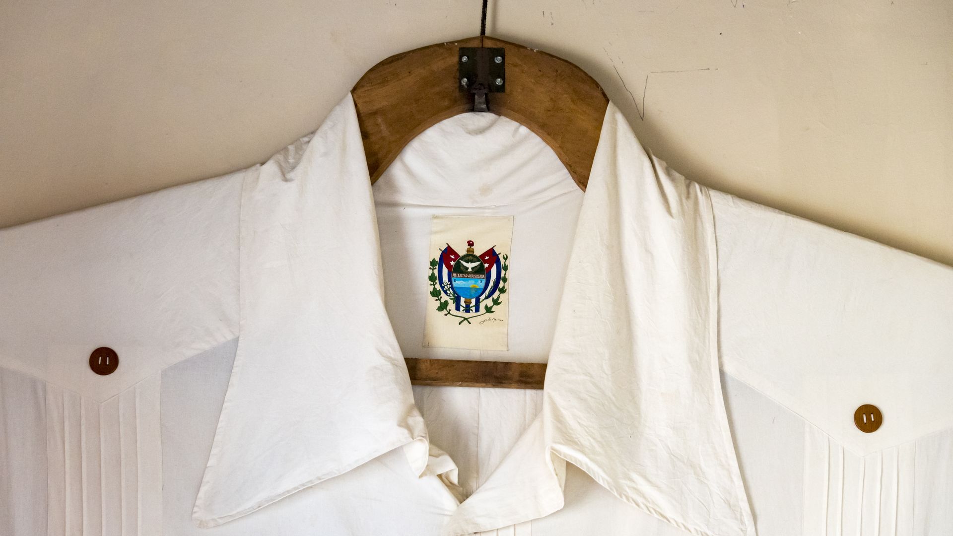 A white shirt with a colorful label inside the collar 