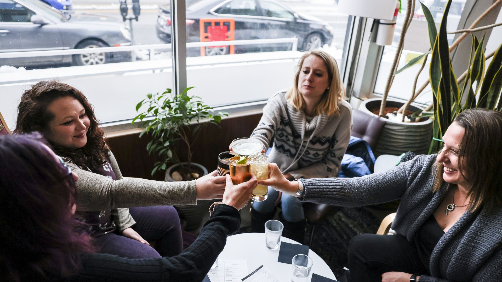 A photo of women toasting with drinks