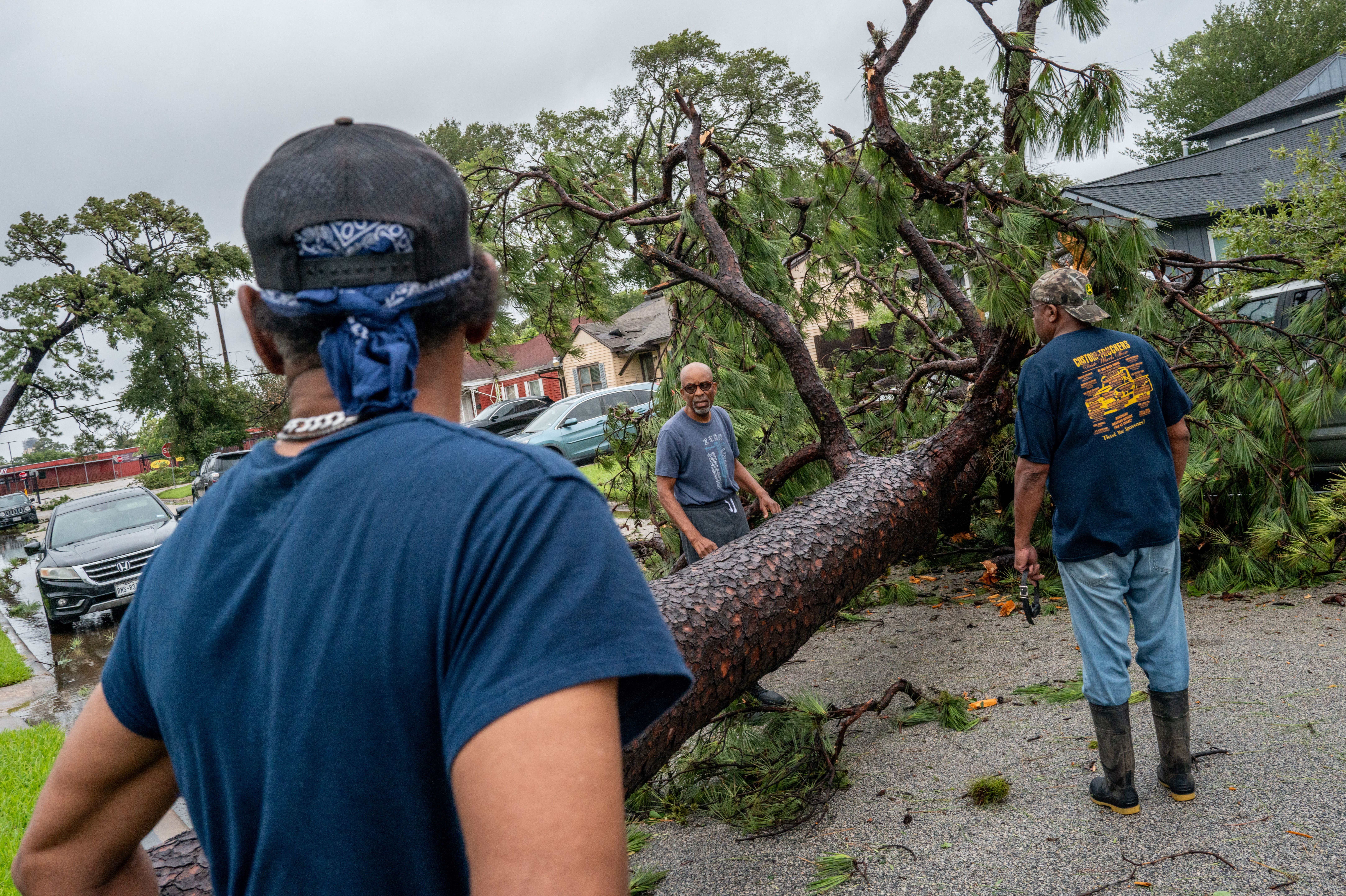 Residents assess a fallen tree in their in their neighborhood after Hurricane Beryl swept through the area on July 08, 2024 in Houston, Texas
