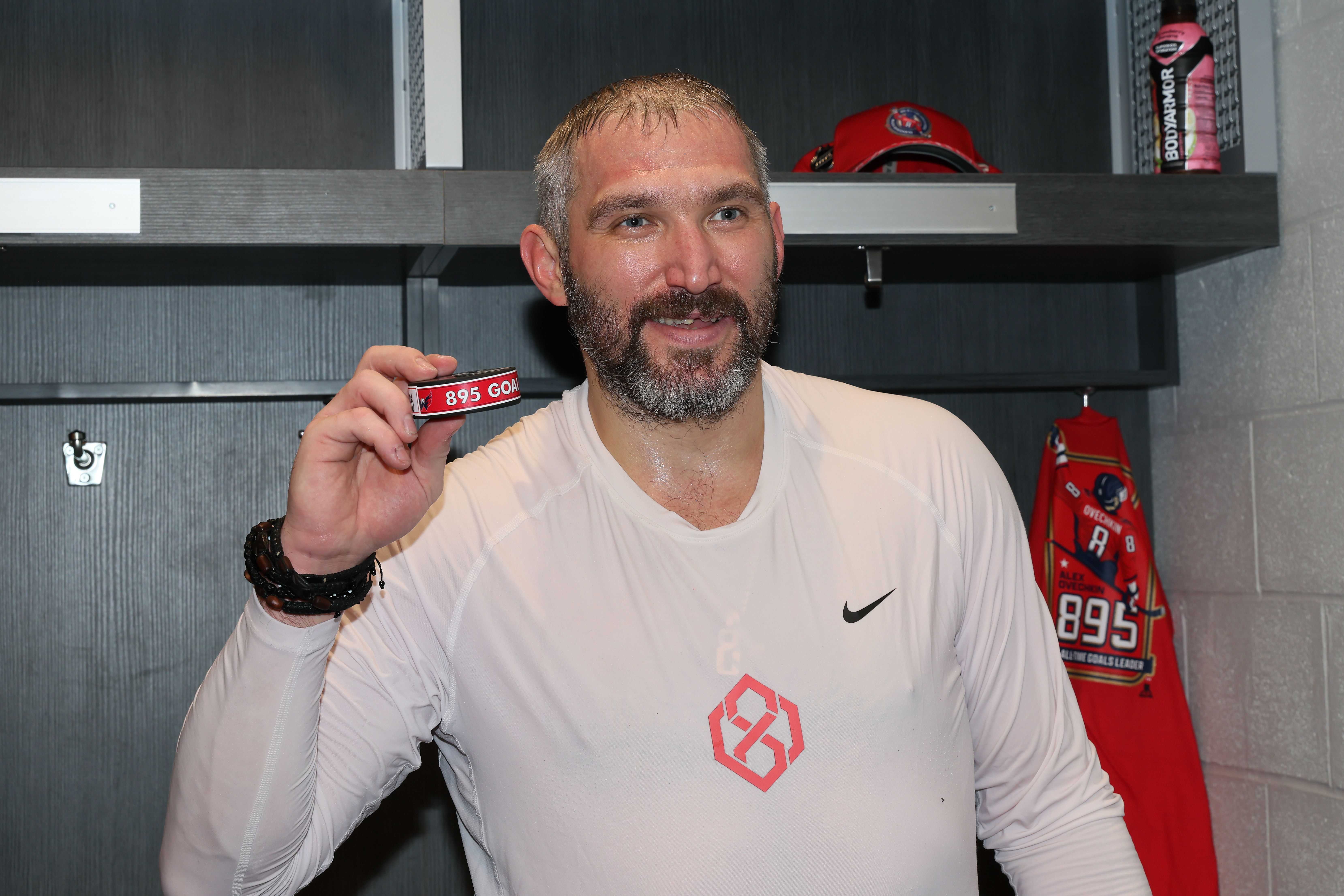 ELMONT, NEW YORK - APRIL 06: Alex Ovechkin #8 of the Washington Capitals poses with the puck used during his 895th career goal in the second period against the New York Islanders at UBS Arena on April 06, 2025 in Elmont, New York. Ovechkin's goal passes Wayne Gretzky's 894 goals to become the NHL al