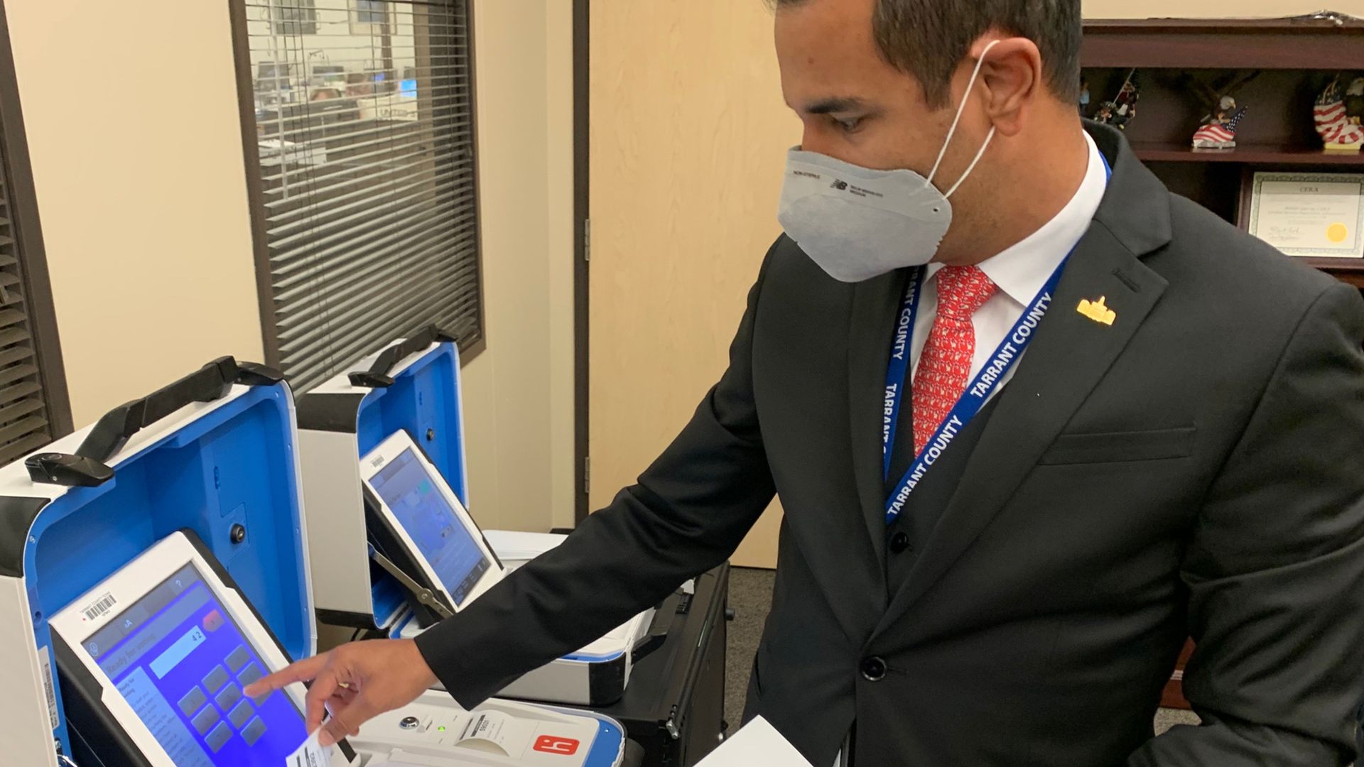 An election official demonstrating a voting machine