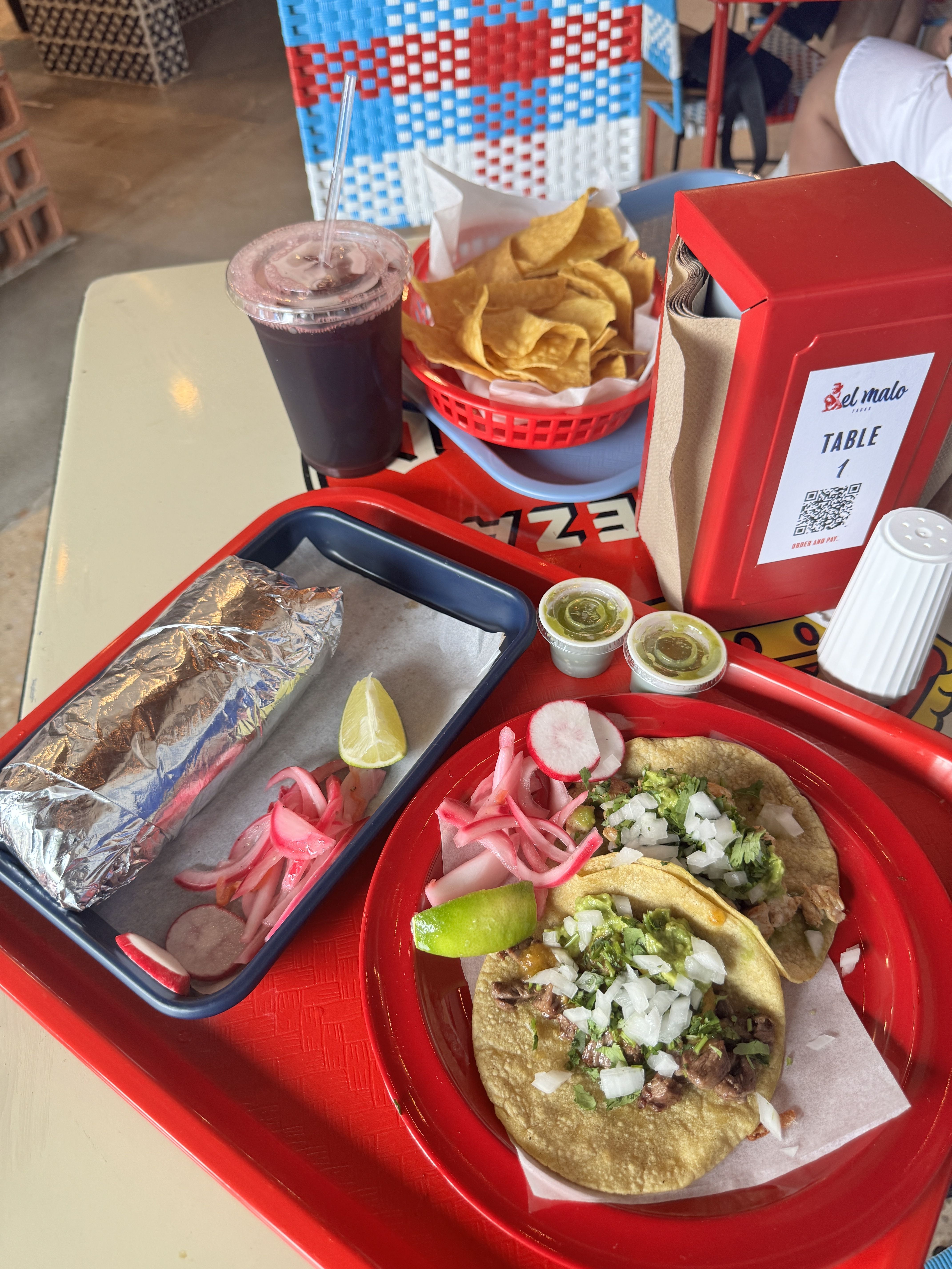 tacos and a burrito on a cafeteria style tray