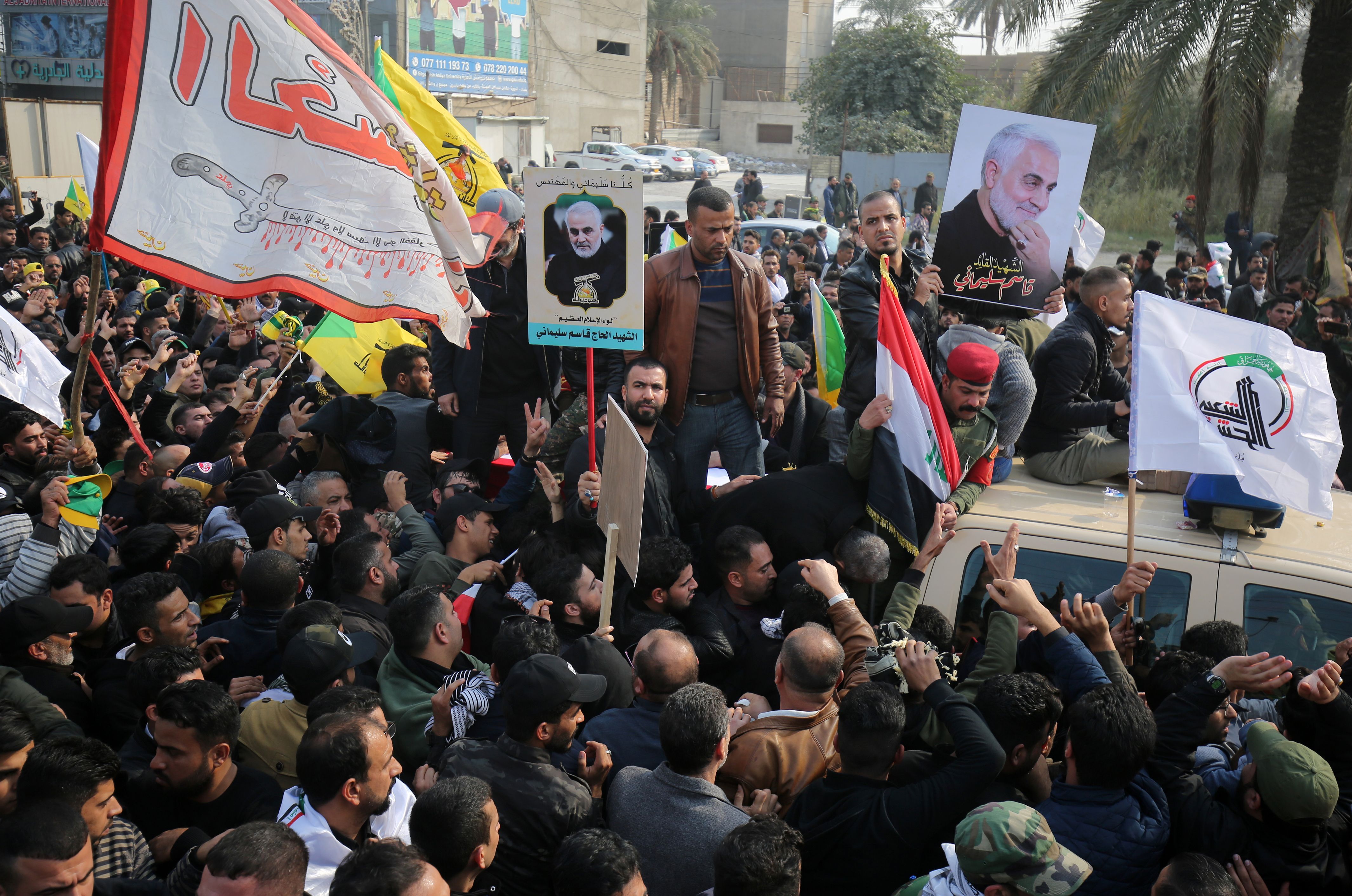 Supporters of the Hashed al-Shaabi paramilitary force attend the funeral procession