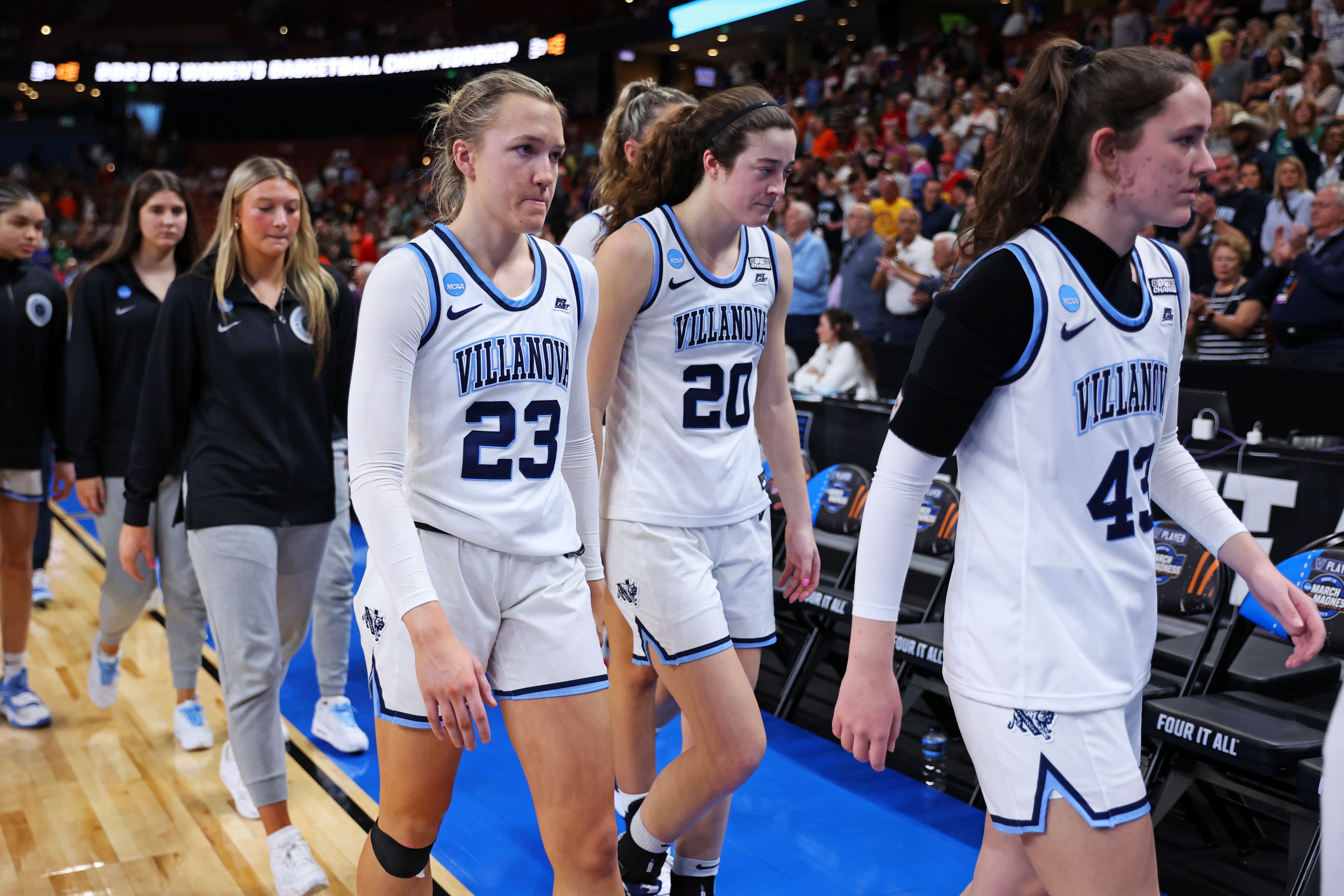 Photo of basketball players leaving a court