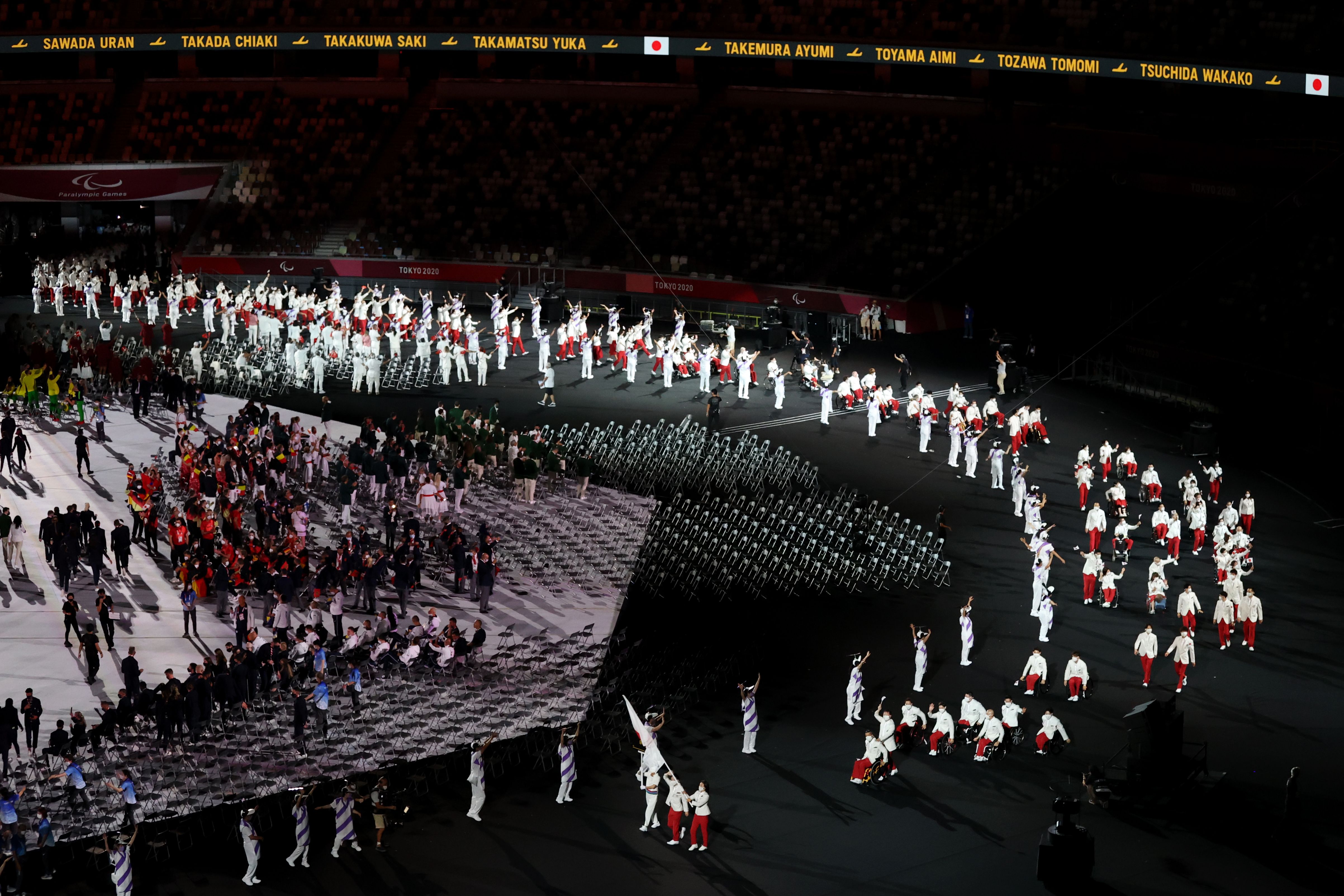 Flag bearers Mami Tani and Koyo Iwabuchi of Team Japan lead their delegation in the parade of athlete during the opening ceremony of the Tokyo 2020 Paralympic Games