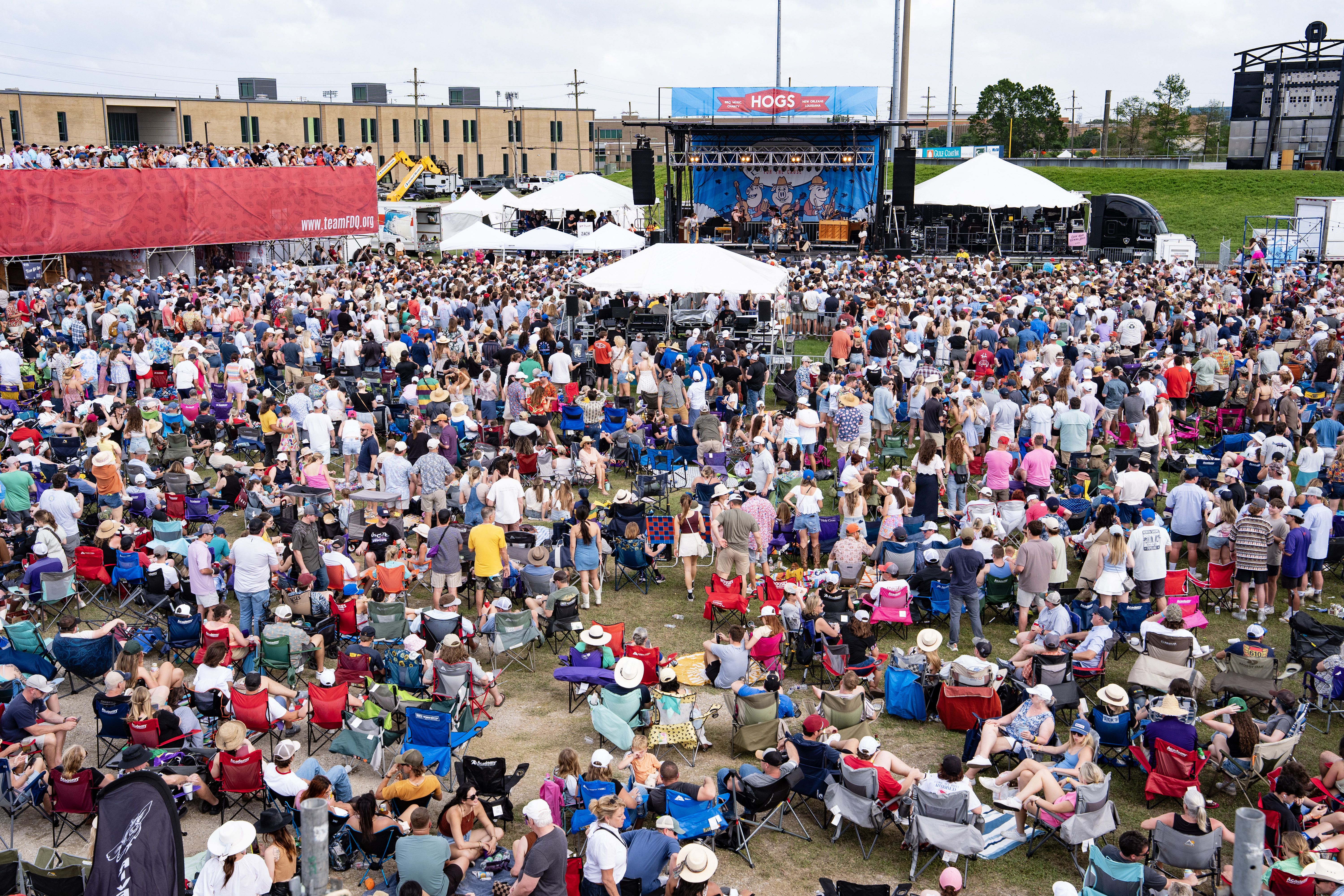 Photo shows people spread out and listening to music.