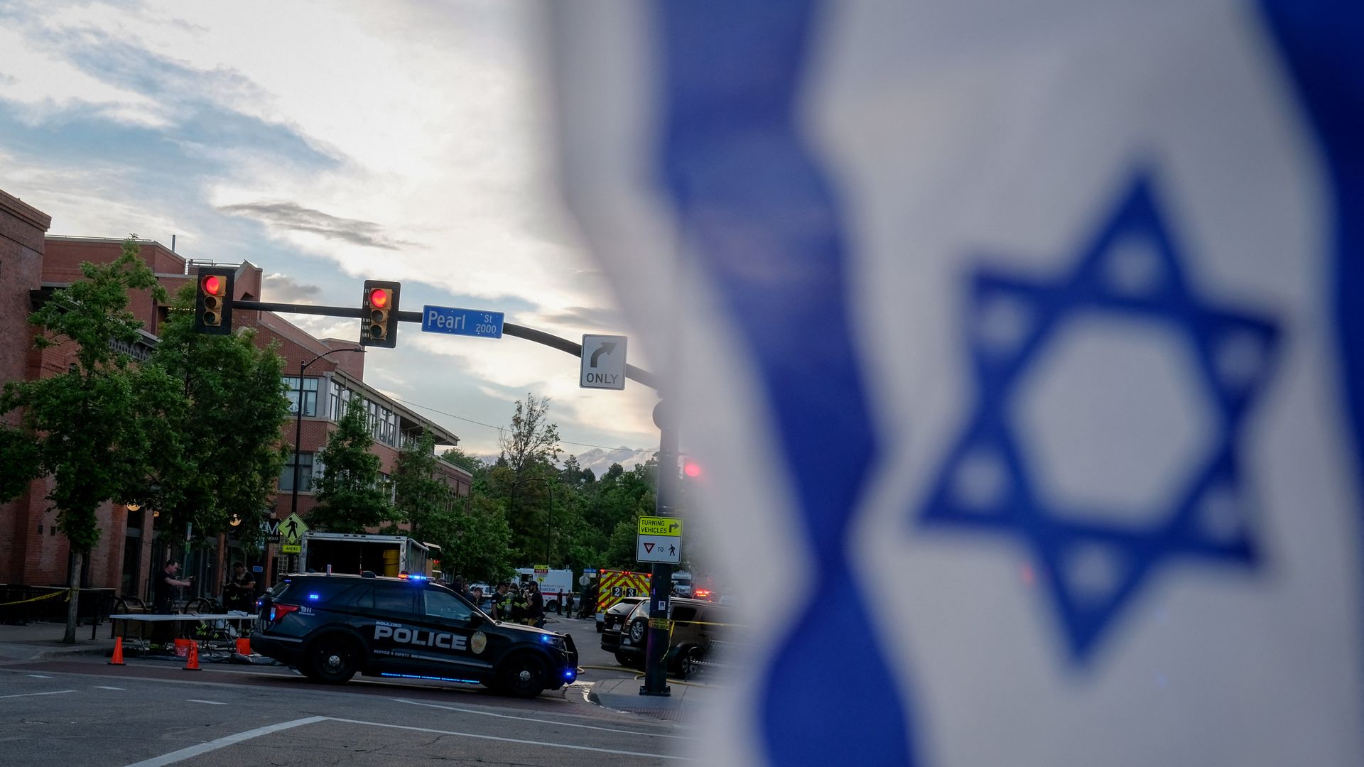 An Israeli flag hangs as police investigate an attack on Pearl Street.