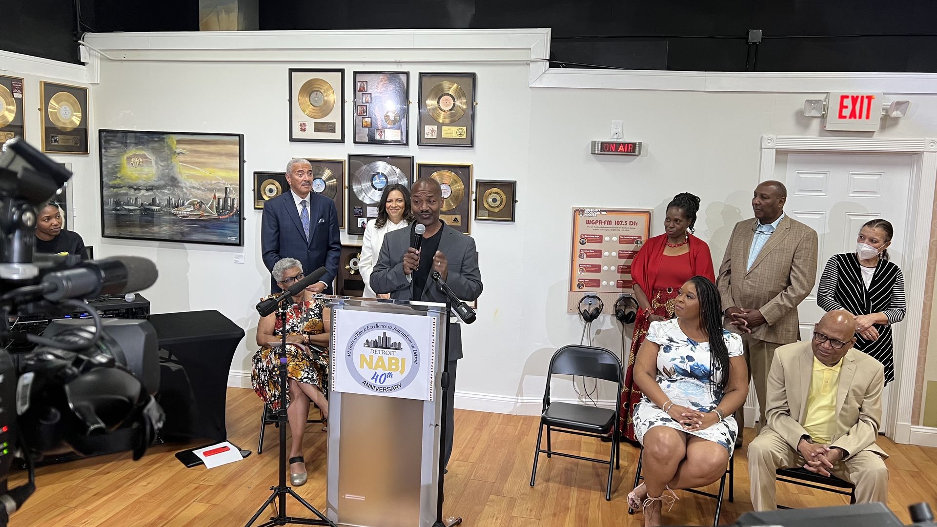 Detroit's Ken Coleman, a longtime legislative reporter speaks in front of a podium