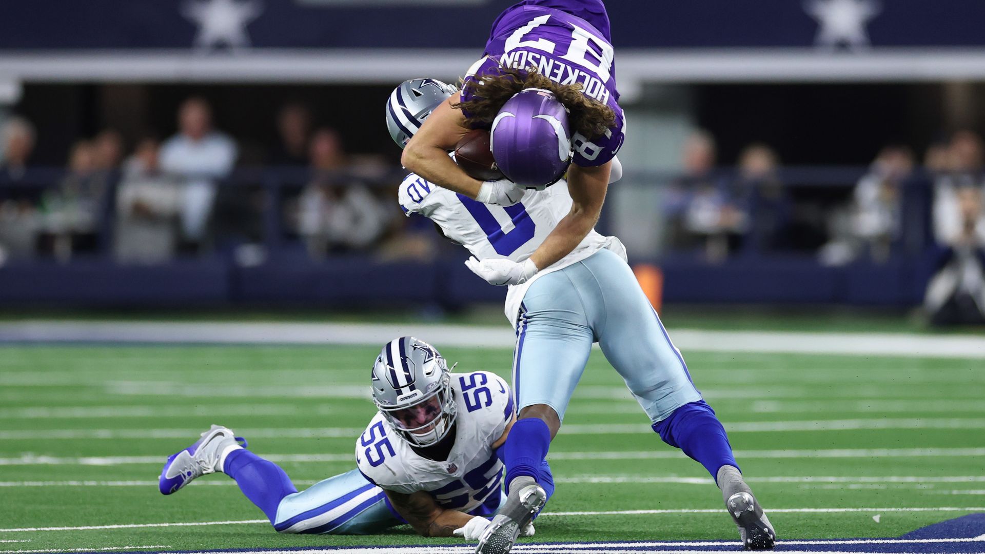 T.J. Hockenson #87 of the Minnesota Vikings is tackled by Demarvion Overshown #0 of the Dallas Cowboys at AT&T Stadium.