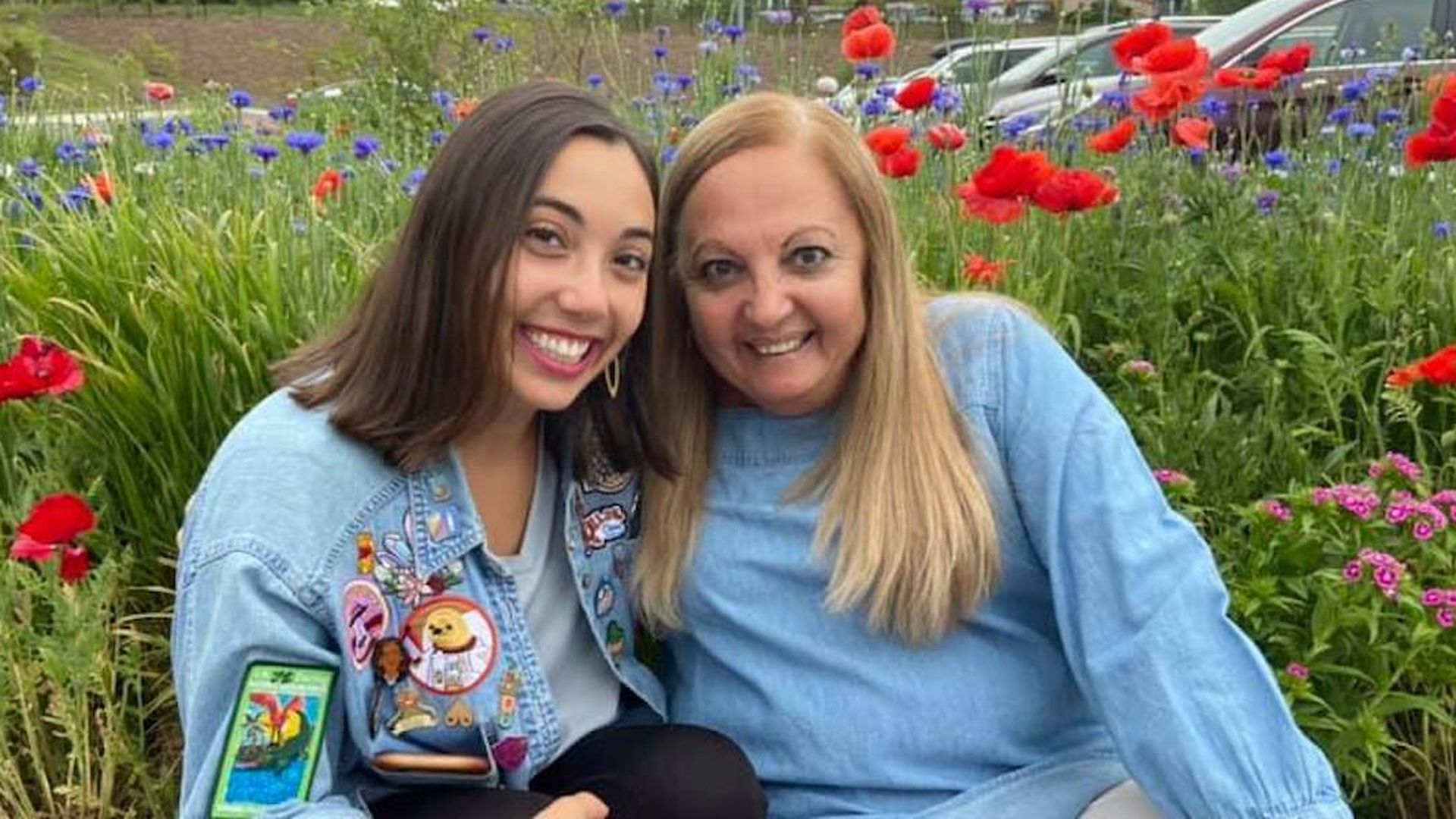 Selene and her mom posing in a bed of wildflowers