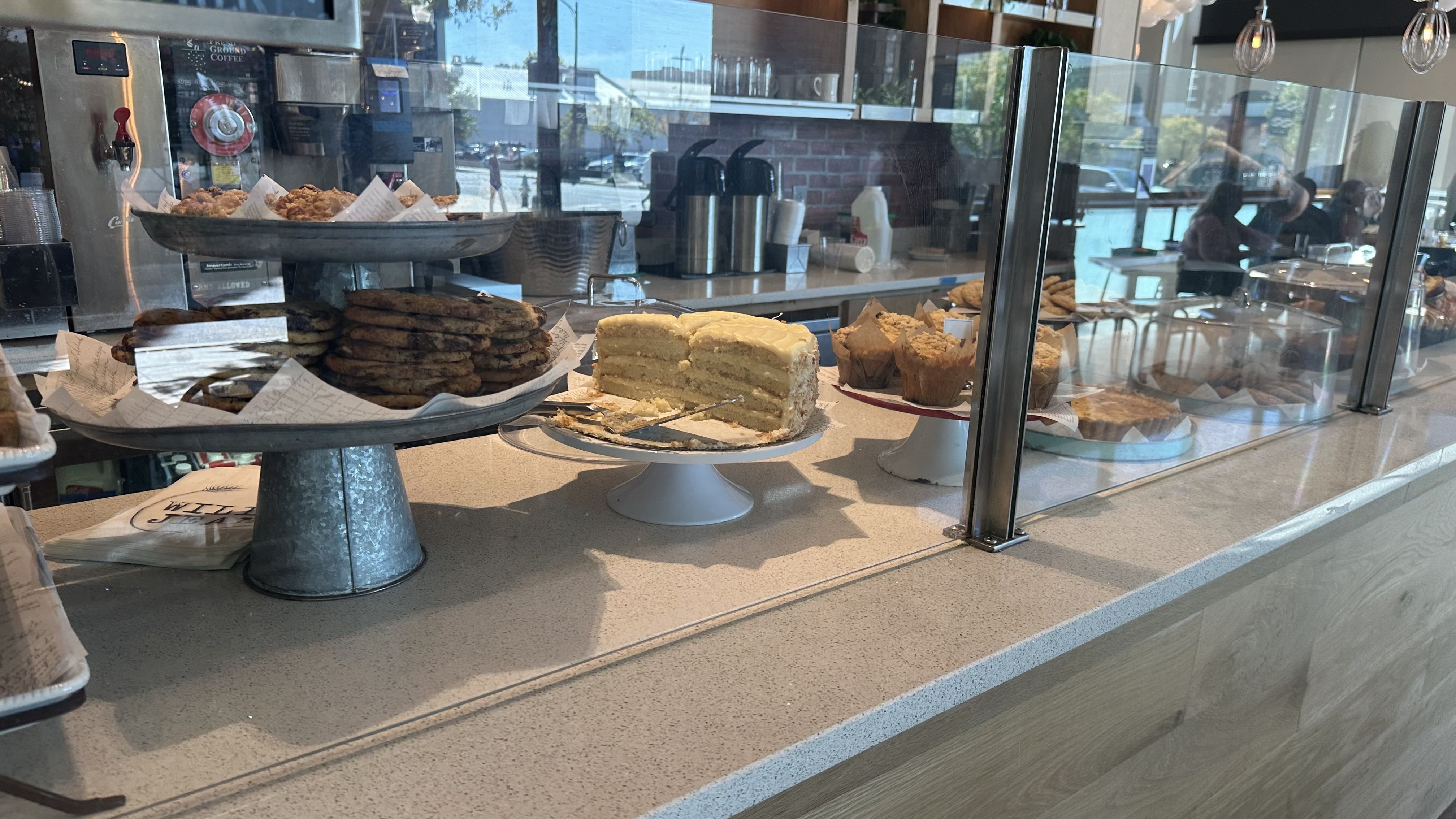 A photo of a pastry case with various desserts.