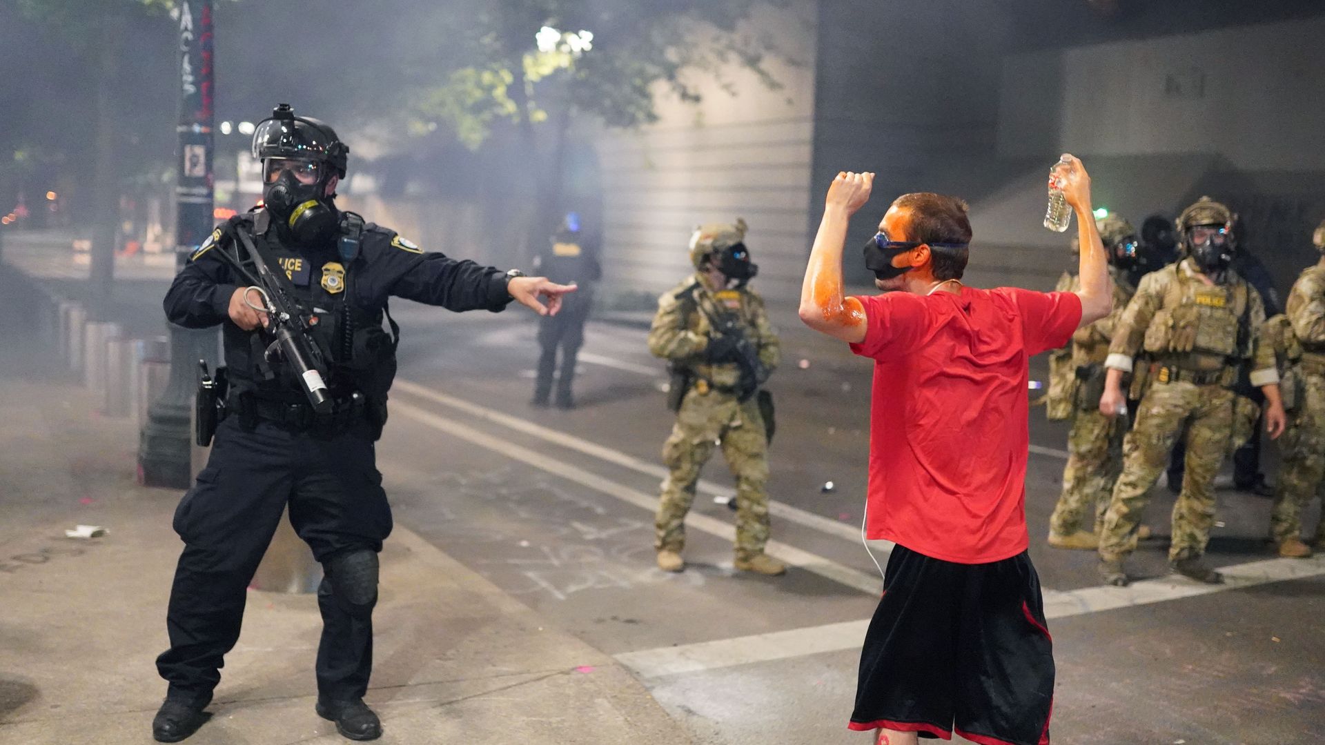 A federal officer tells fellow officers to arrest a protester in front of the Mark O. Hatfield U.S. Courthouse on July 21, 2020 in Portland, Oregon.