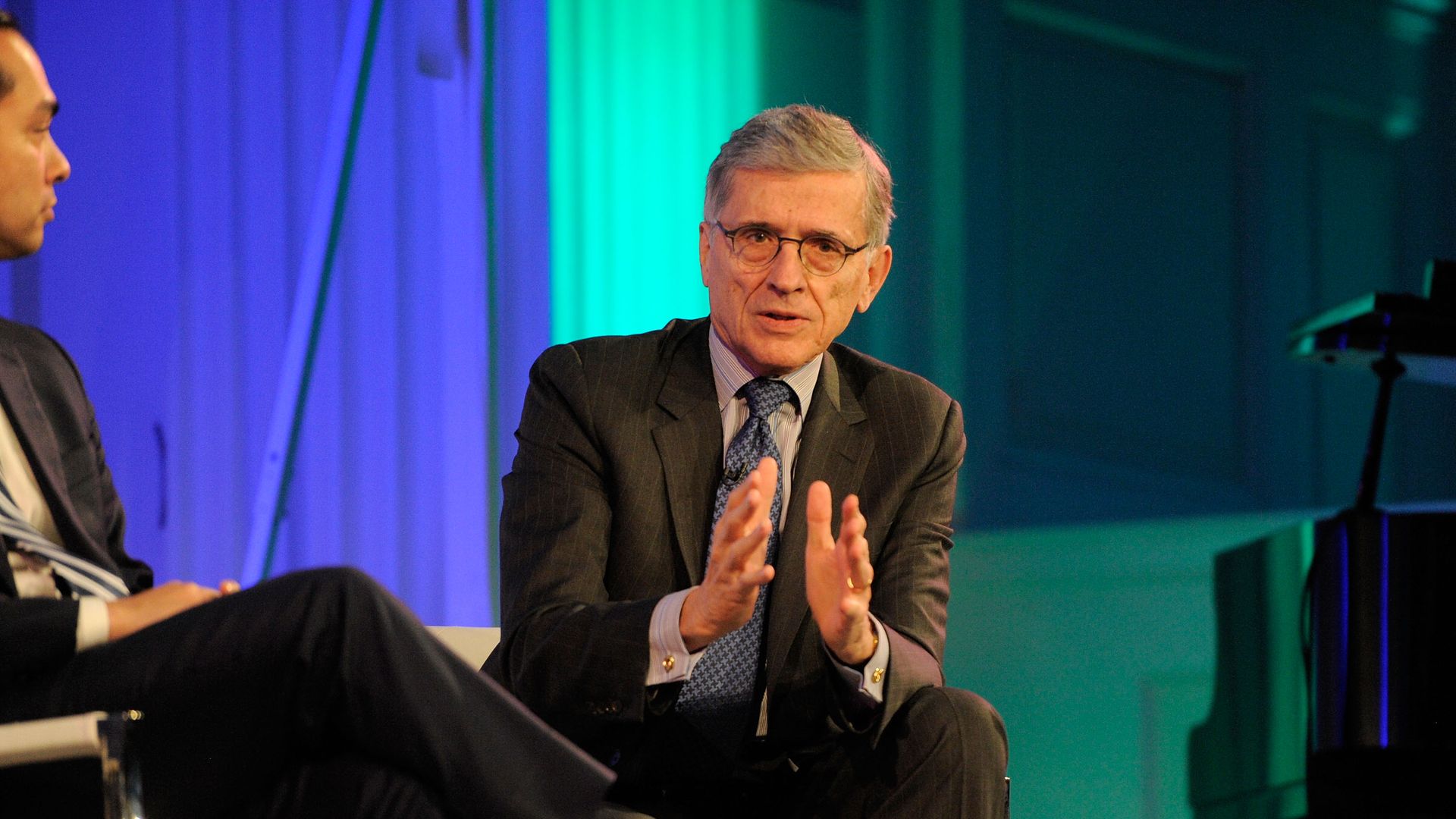 Tom Wheeler on stage in a suit