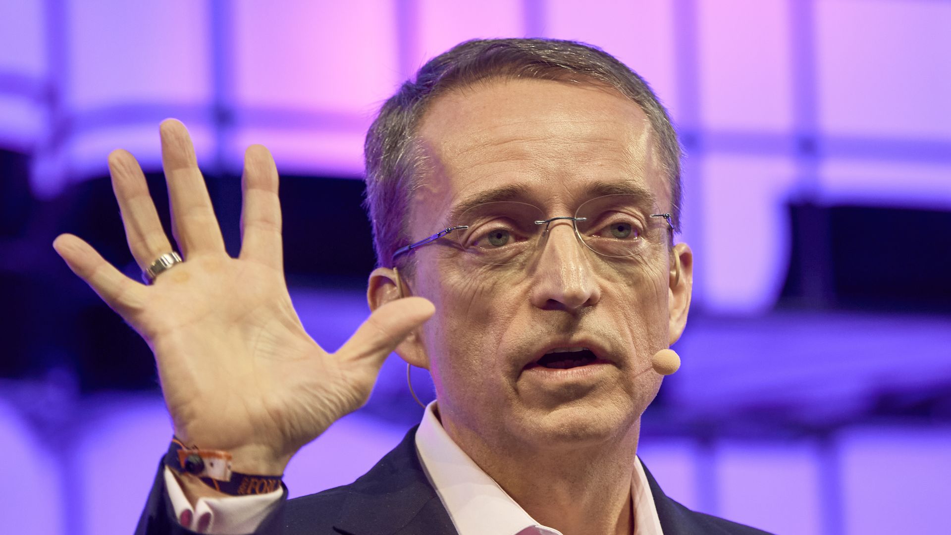 Intel CEO Pat Gelsinger holds up five fingers.