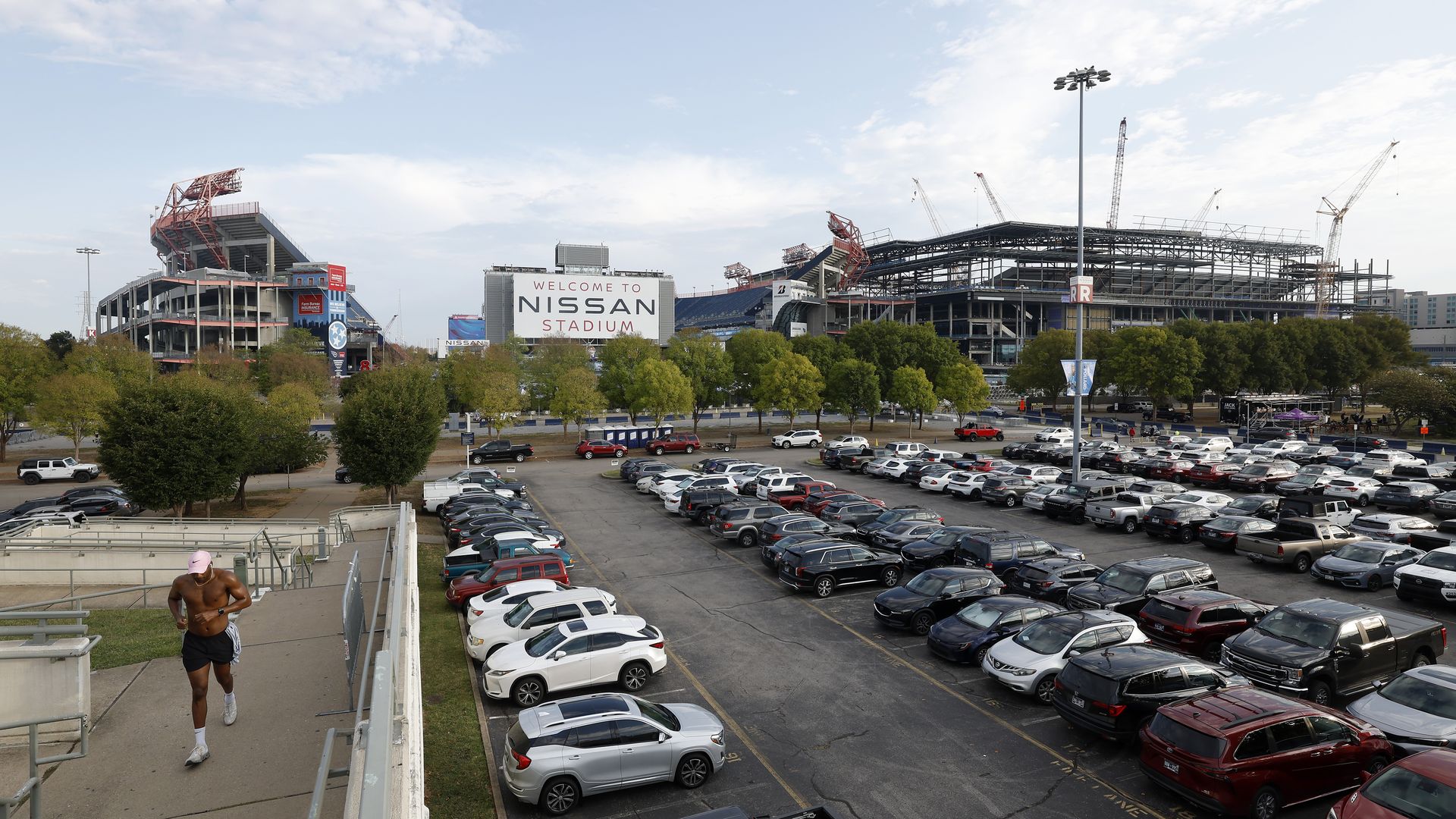 A view of Nissan Stadium and construction of the New Nissan Stadiumright next door with cranes overhead.