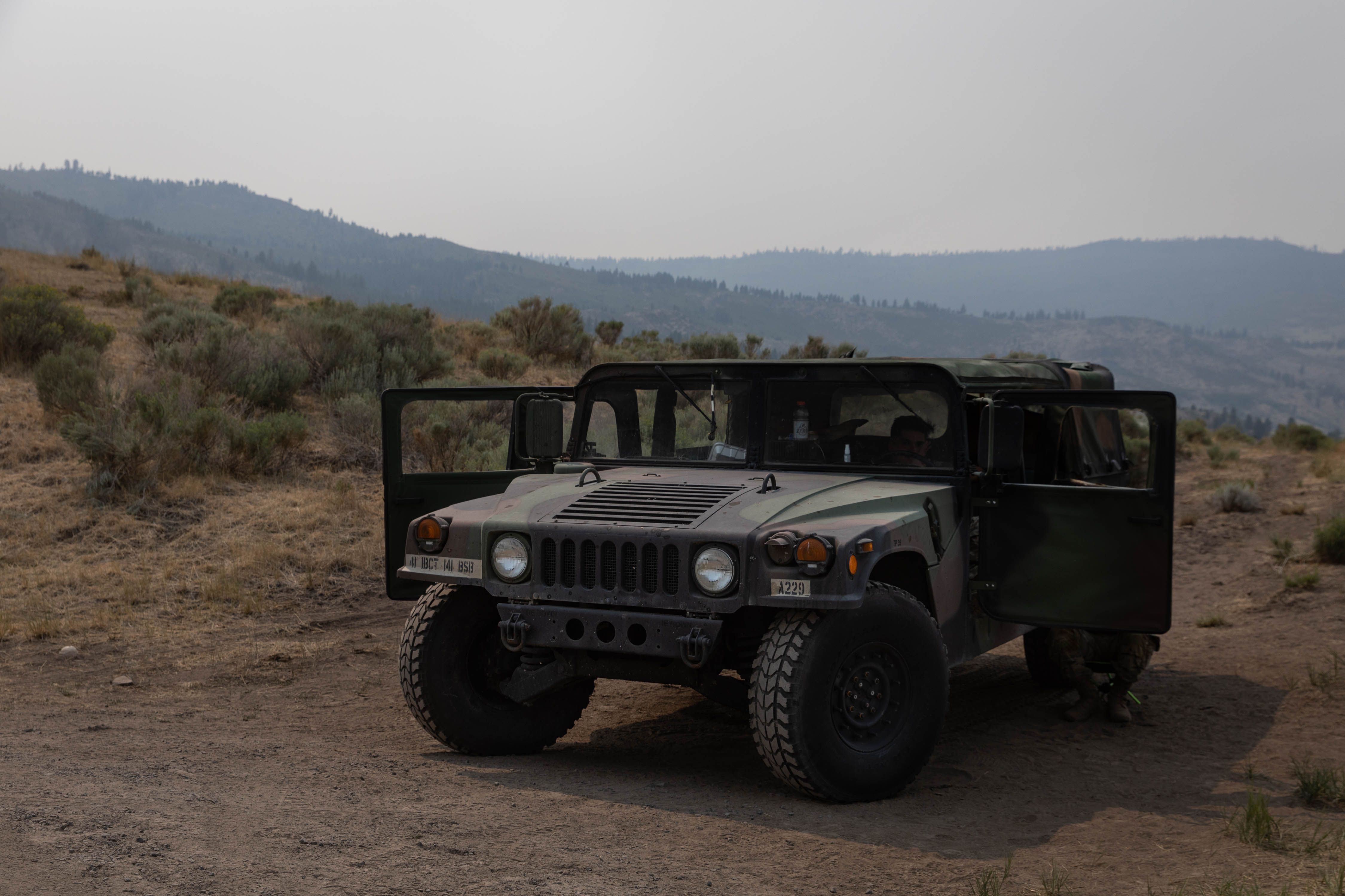 A National Guard Humvee stationed at a closed juncture during the Bootleg Fire, in the mountains outside of Lakeside, Oregon, U.S., on Saturday, July 24