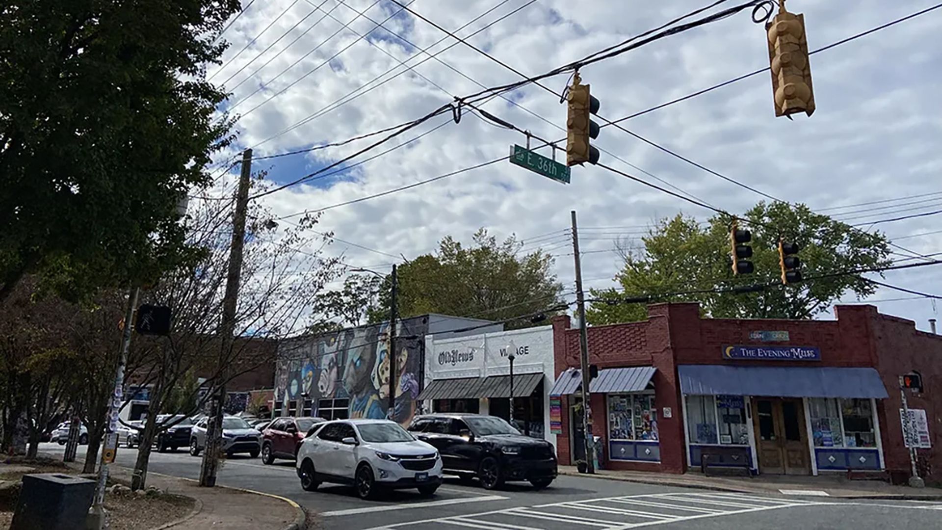 Cars on the street in front of downtown businesses