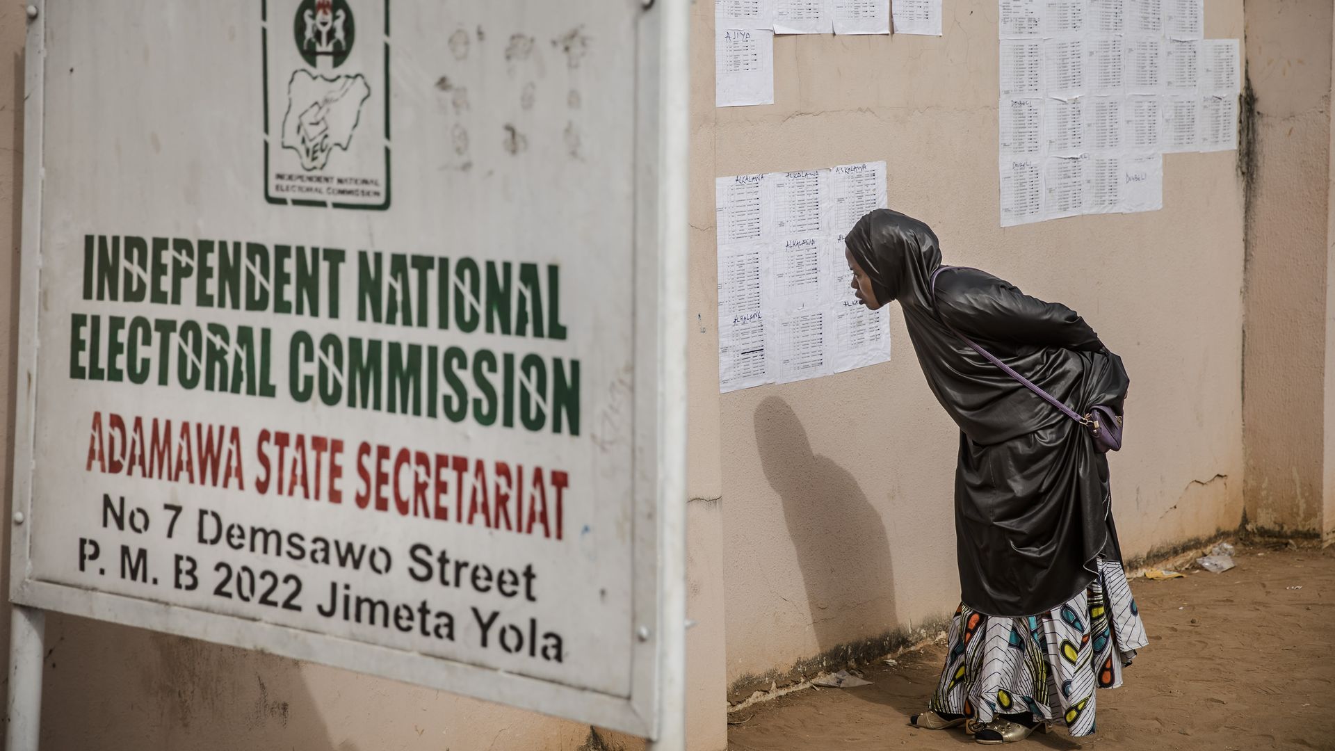 Woman looks at information near Independent Electoral Commission.