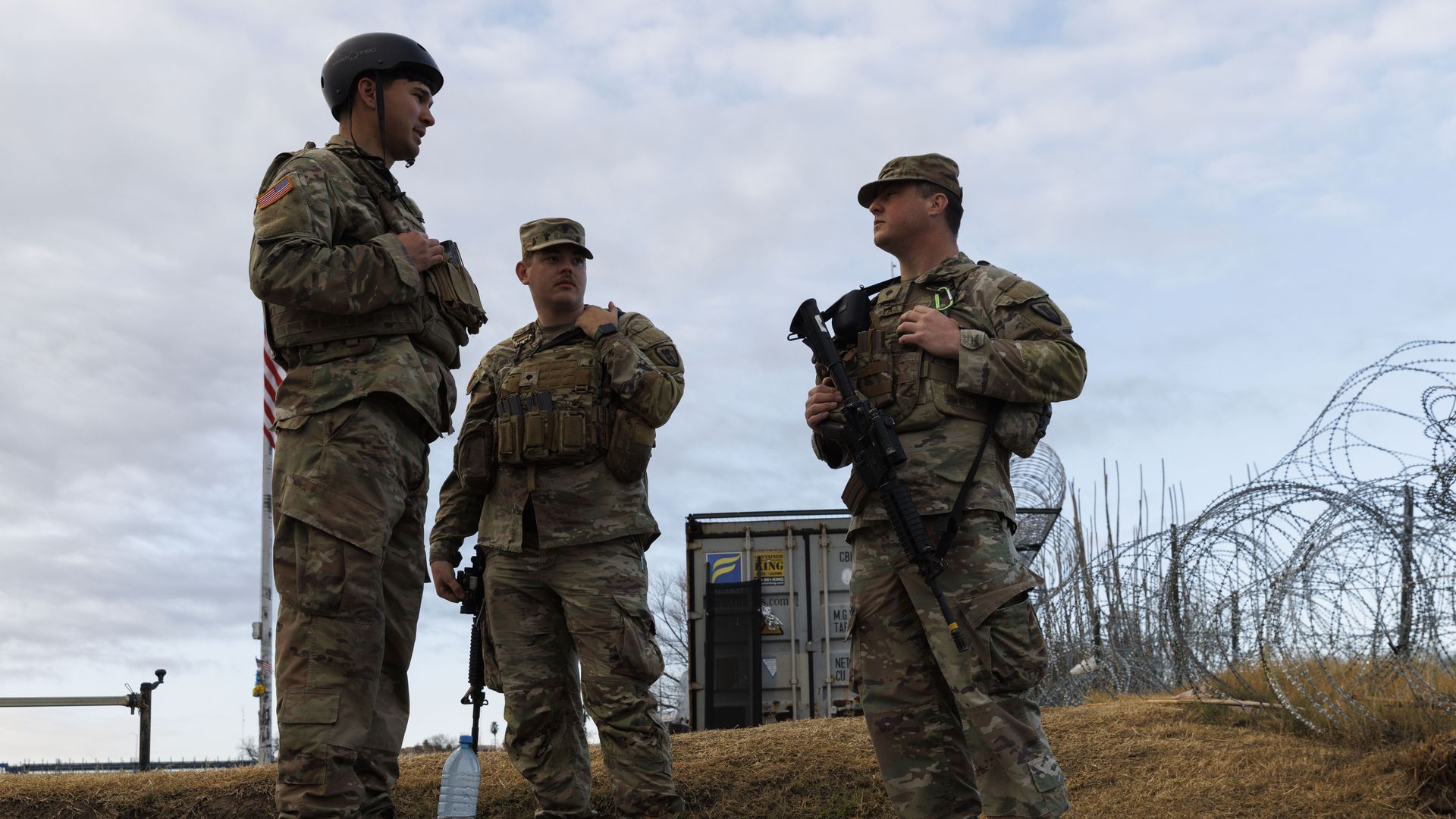  Texas National Guard soldiers wait nearby the boat ramp where law enforcement enter the Rio Grande at Shelby Park on January 26, 2024 in Eagle Pass, Texas. 