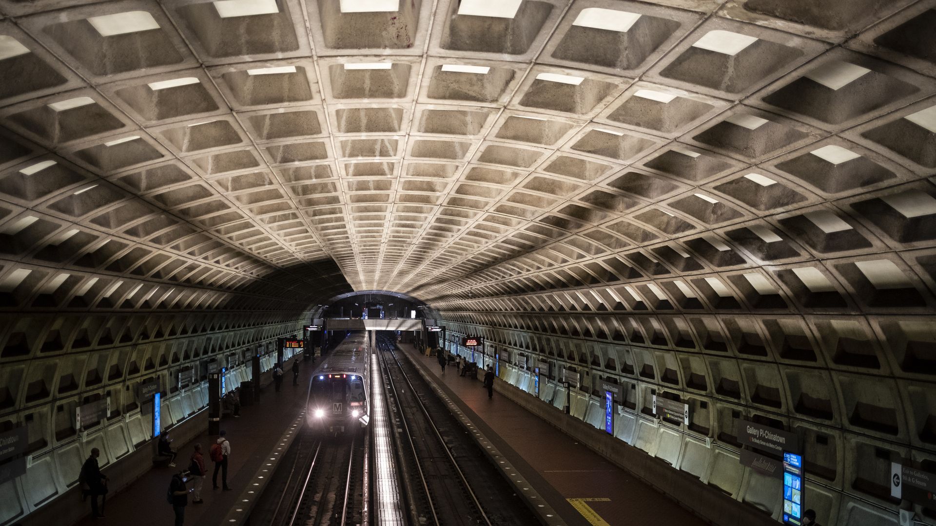 An image of a Metro train pulling up into the Gallery Place-Chinatown station.