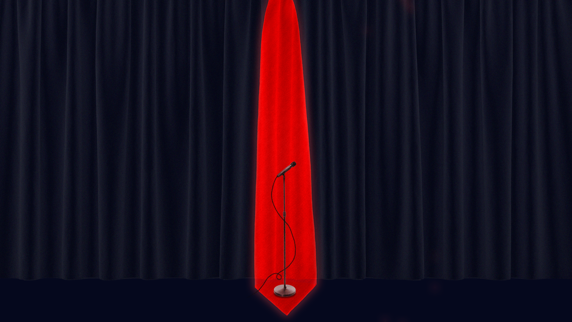 A microphone on stage in front of a curtain in the shape of a large red tie