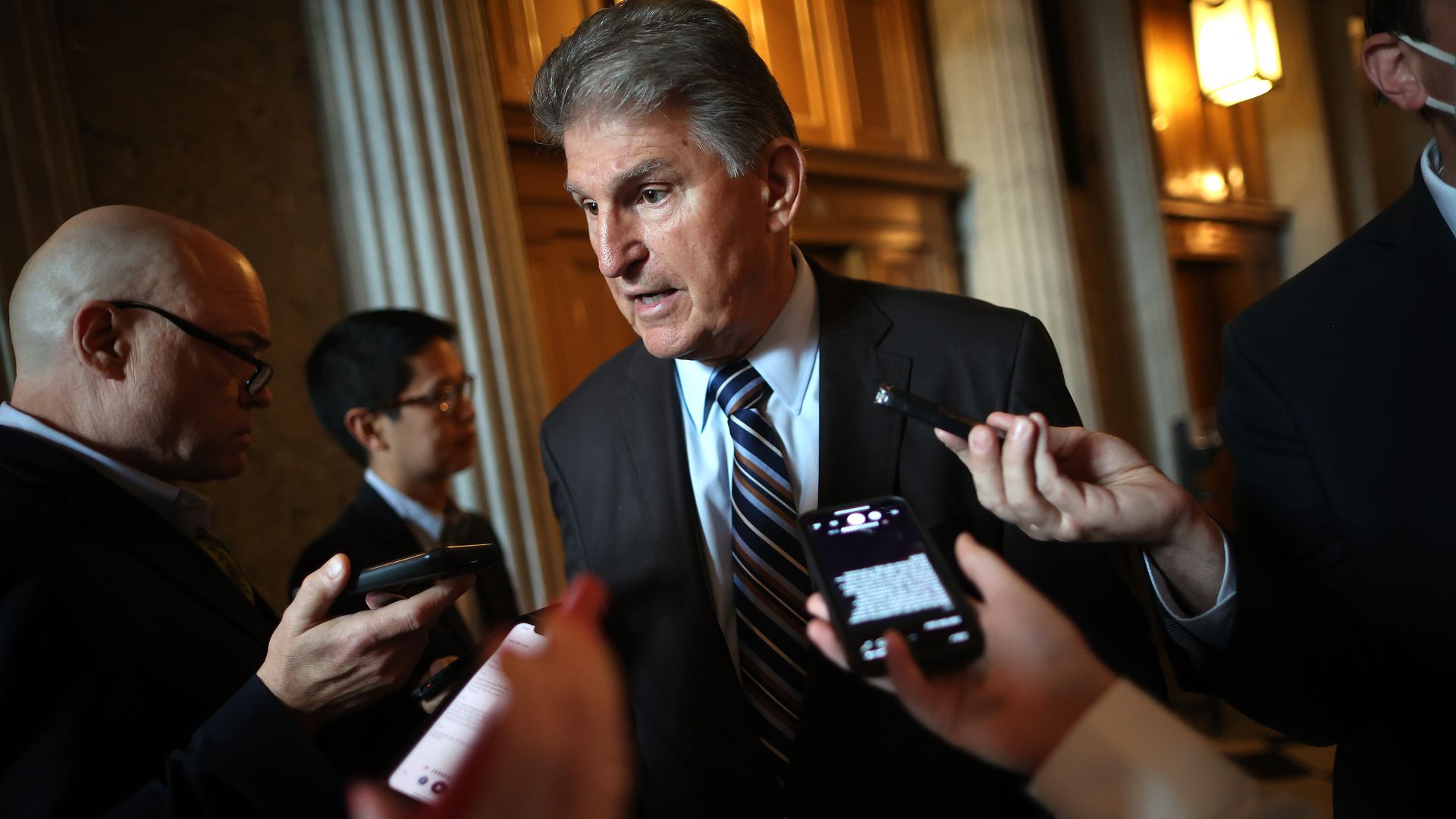 Picture of Joe Manchin surrounded by reporters