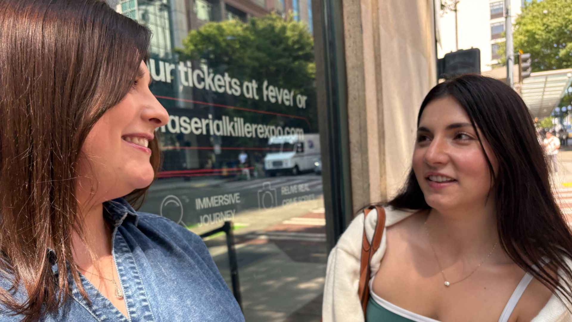 Two women outside a serial killer exhibit talk about what they saw.
