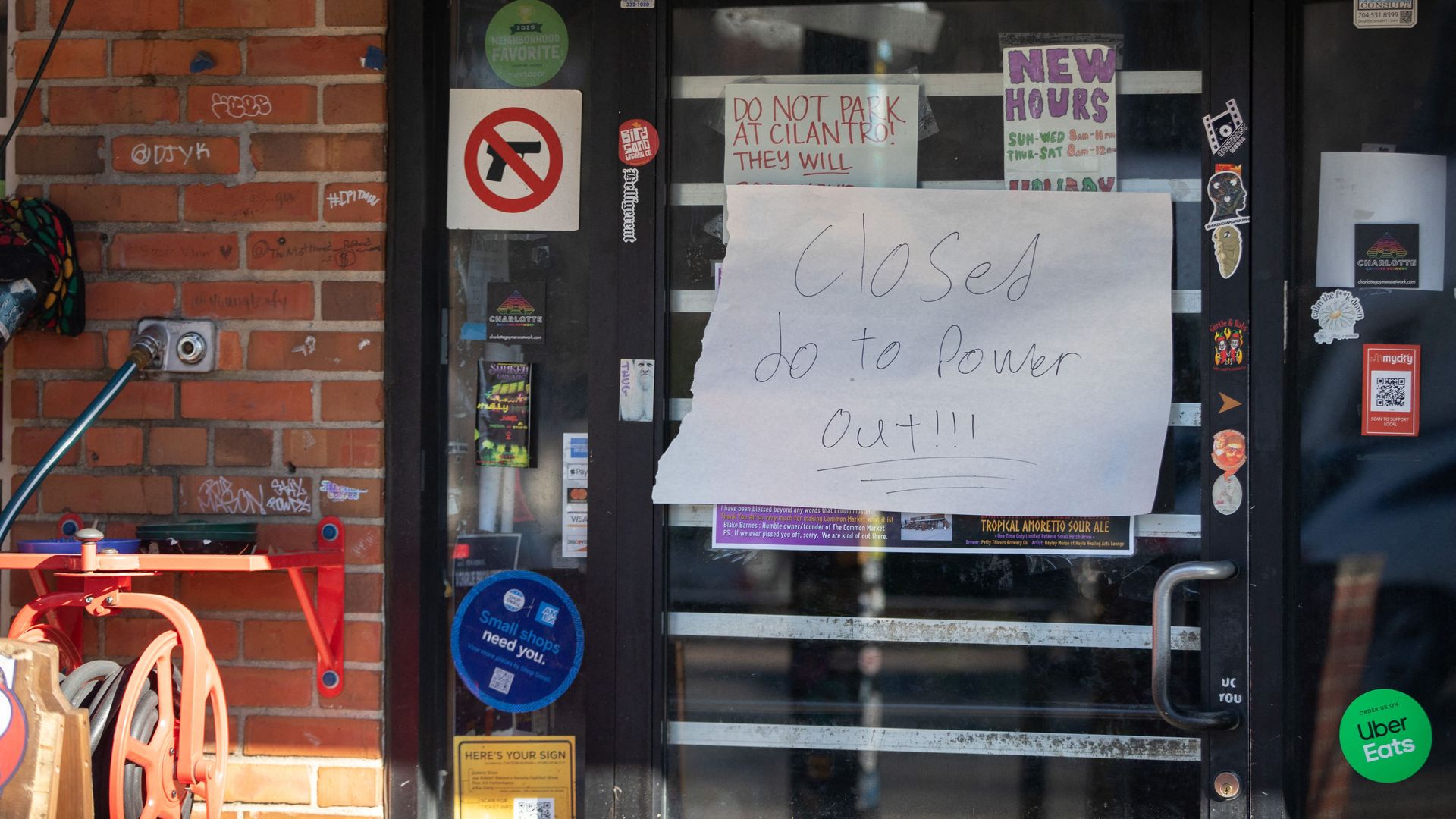 A sign informs patrons of a store closure due to widespread power outages at Common Market in the Plaza Midwood neighborhood of Charlotte