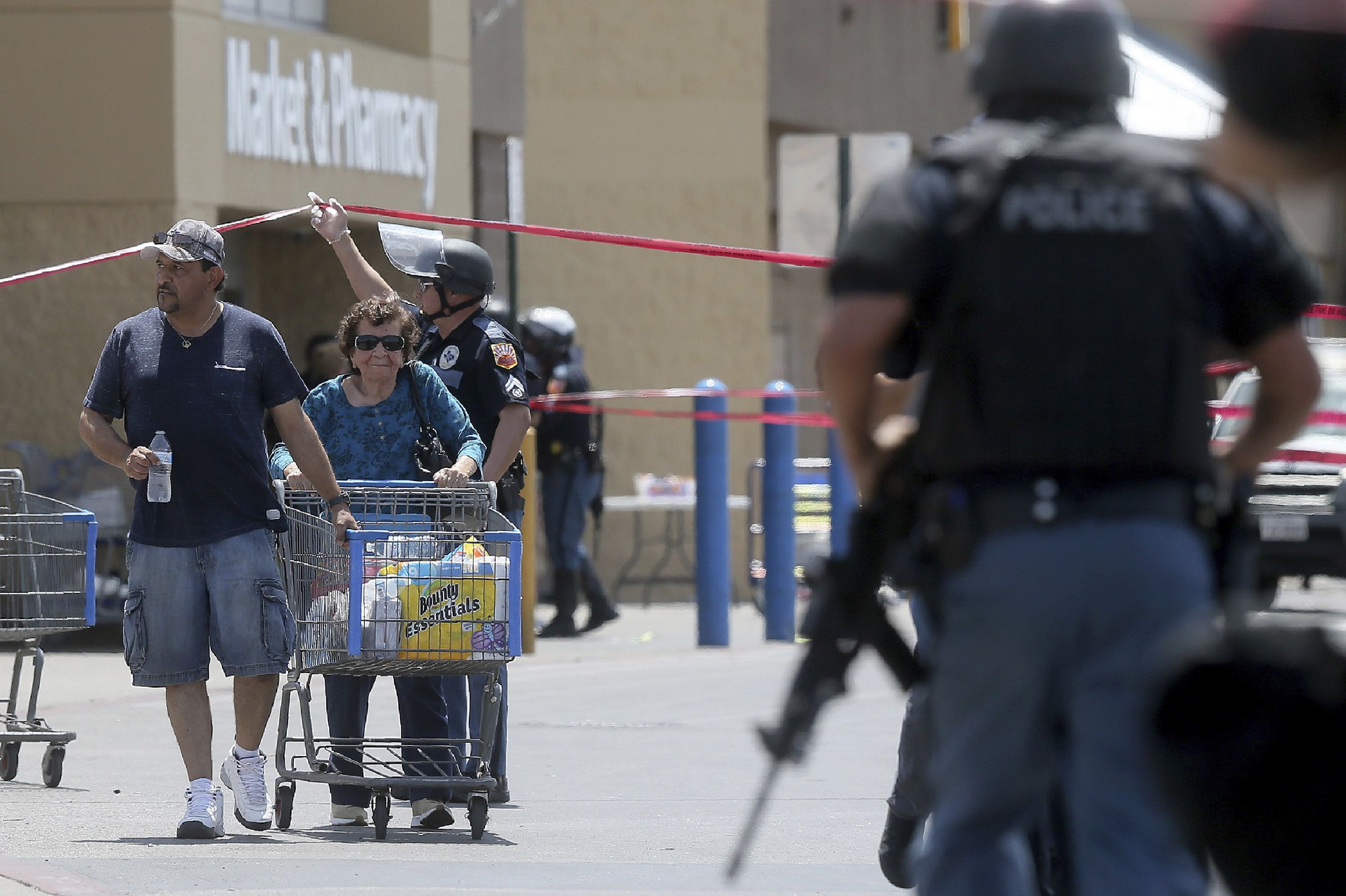 Walmart customers are escorted from the store after a gunman opened fire on shoppers near the Cielo Vista Mall
