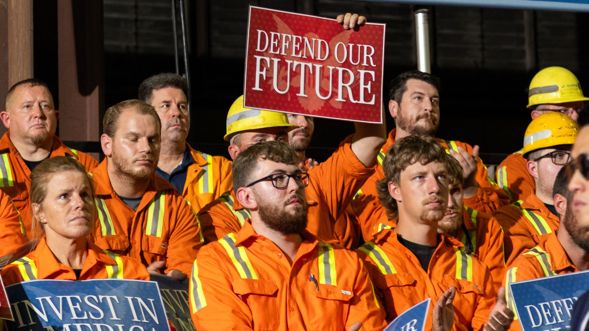 Steelworkers at Cleveland-Cliffs' Middletown Works facility hold signs and applaud.