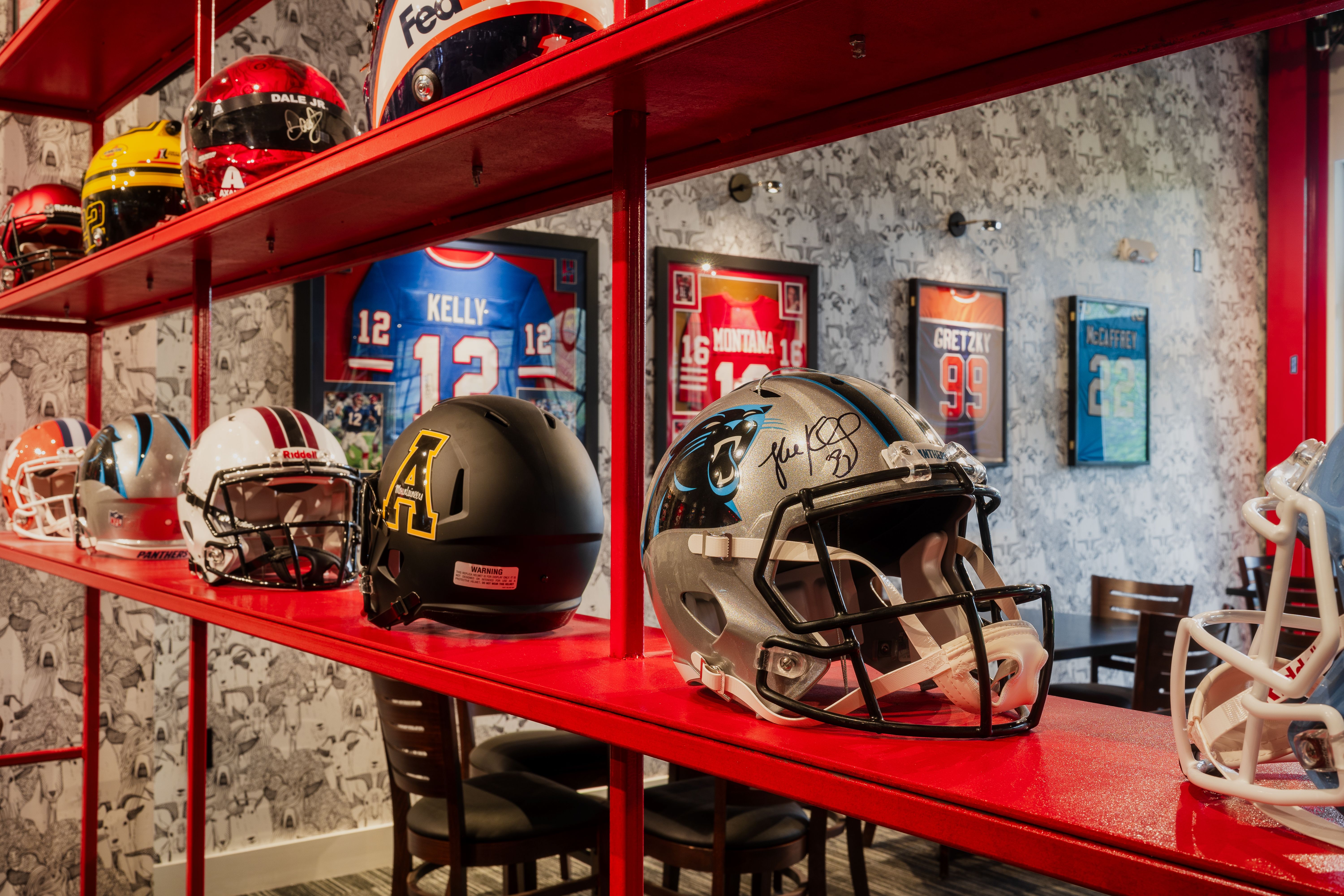 rows of NFL football helmets on a shelf