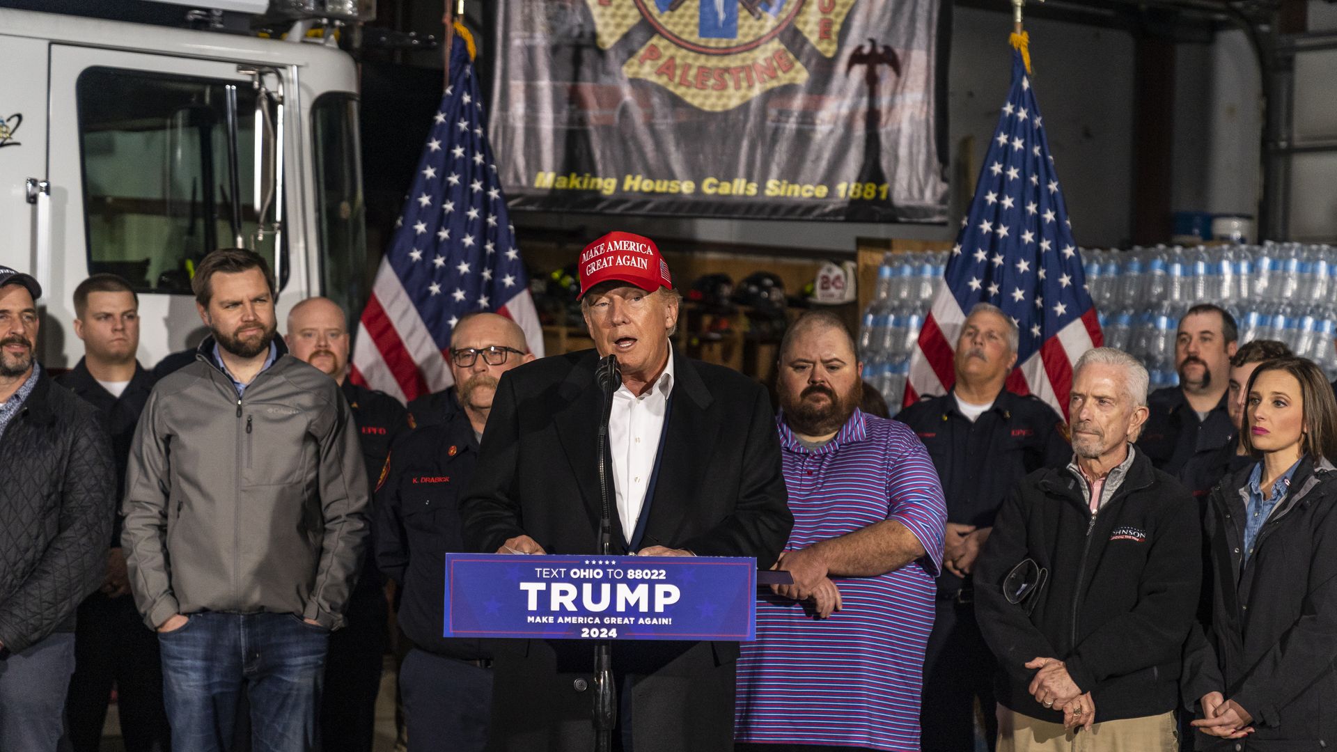 Trump speaking at event in a crowd.