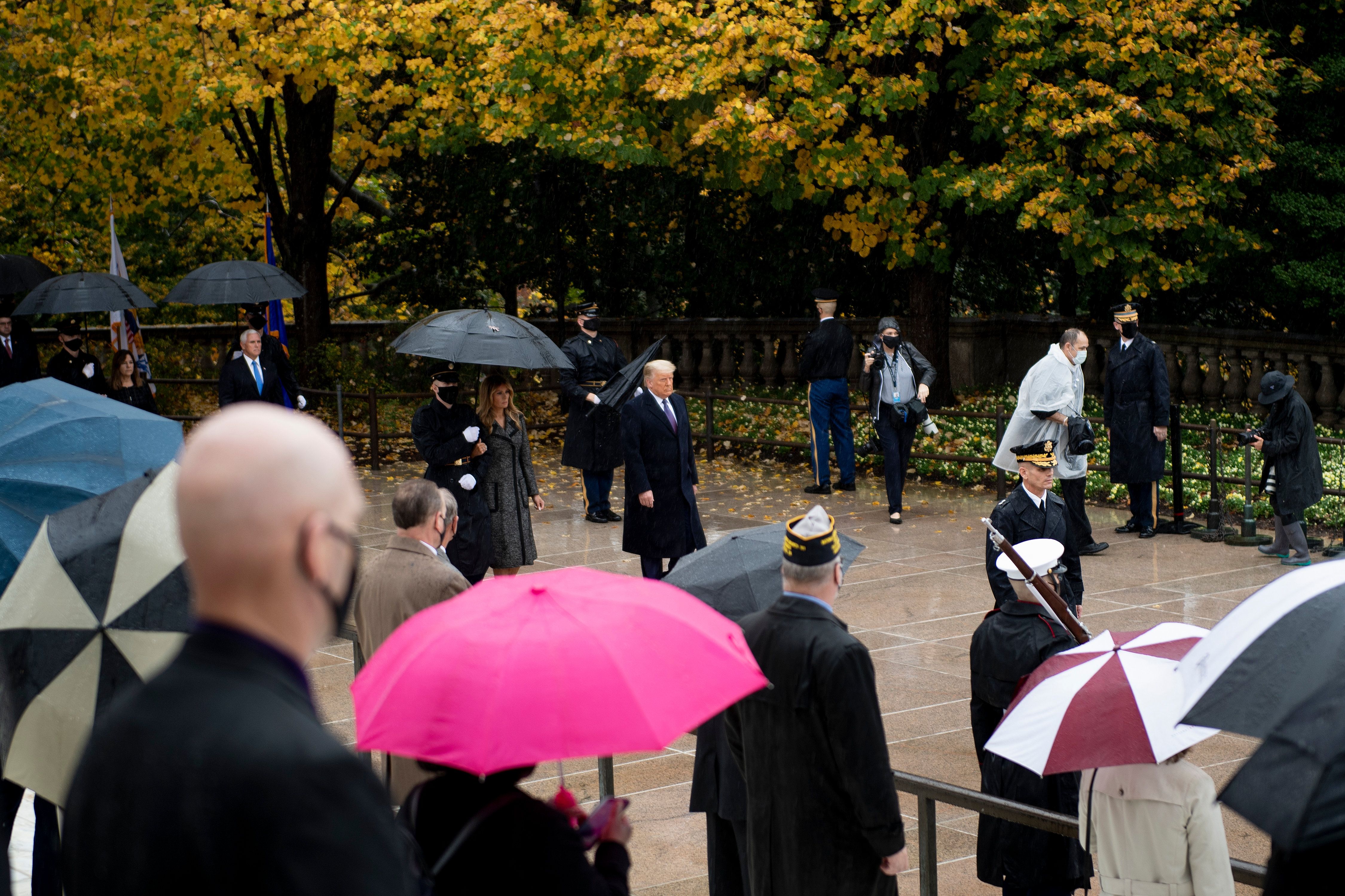 Picture of President Donald Trump, Vice President Mike Pence and First Lady Melania Trump arriving at the Arlington Cemetery in the rain.