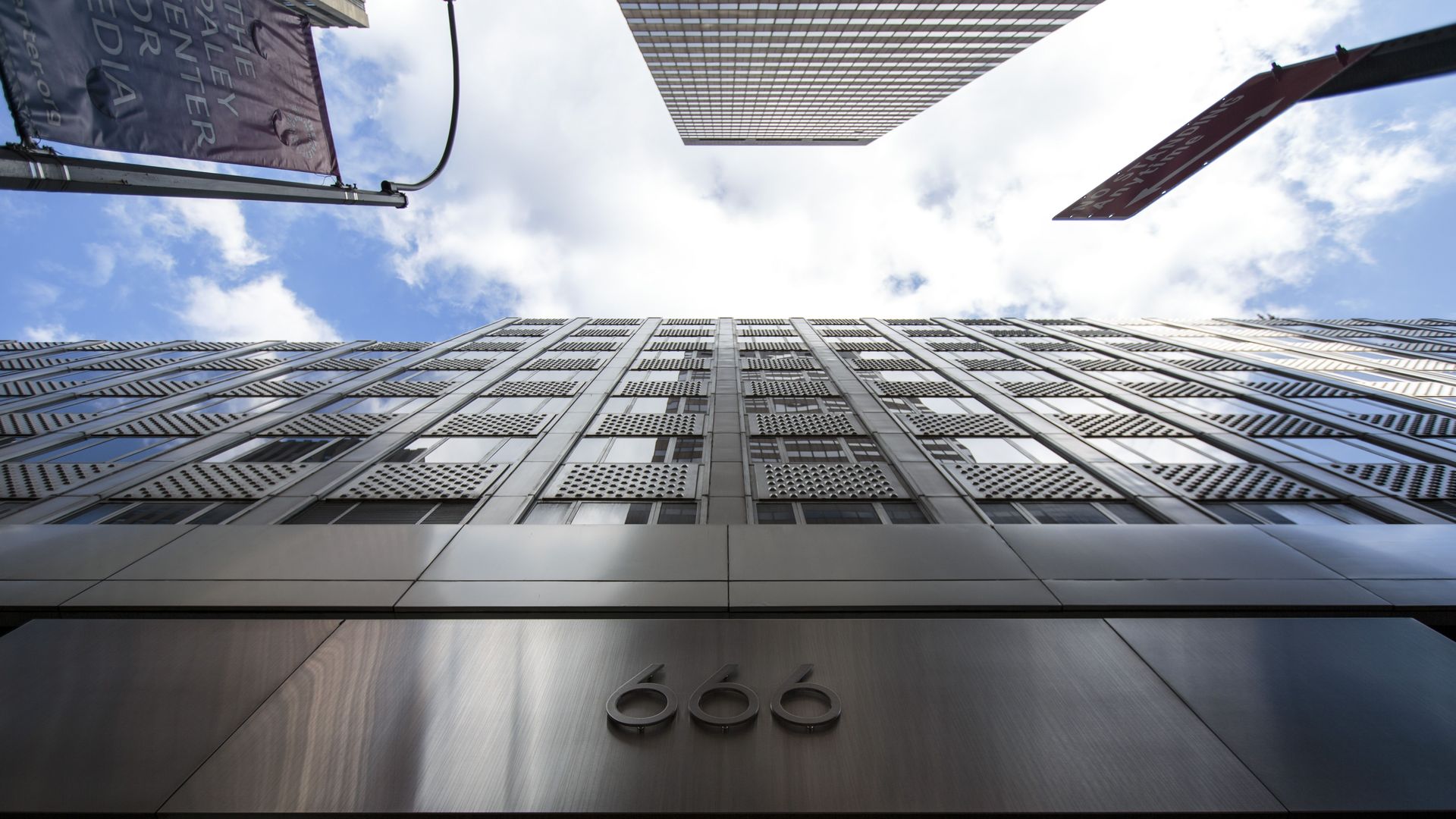 In this image, the camera looks straight up the side of the 666 Fifth Ave skyscraper. 