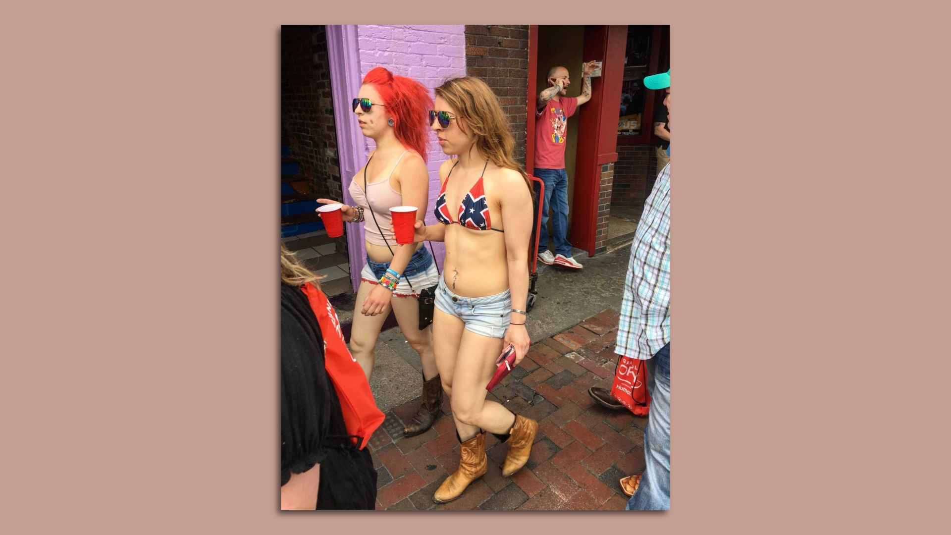 A woman wearing a bikini top with Confederate flag imagery.