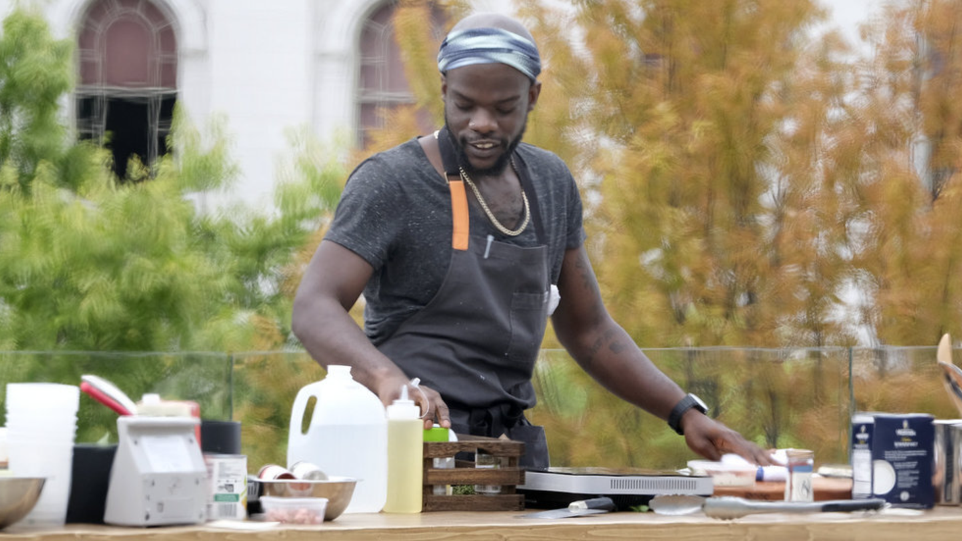 Photo shows Charly Pierre cooking