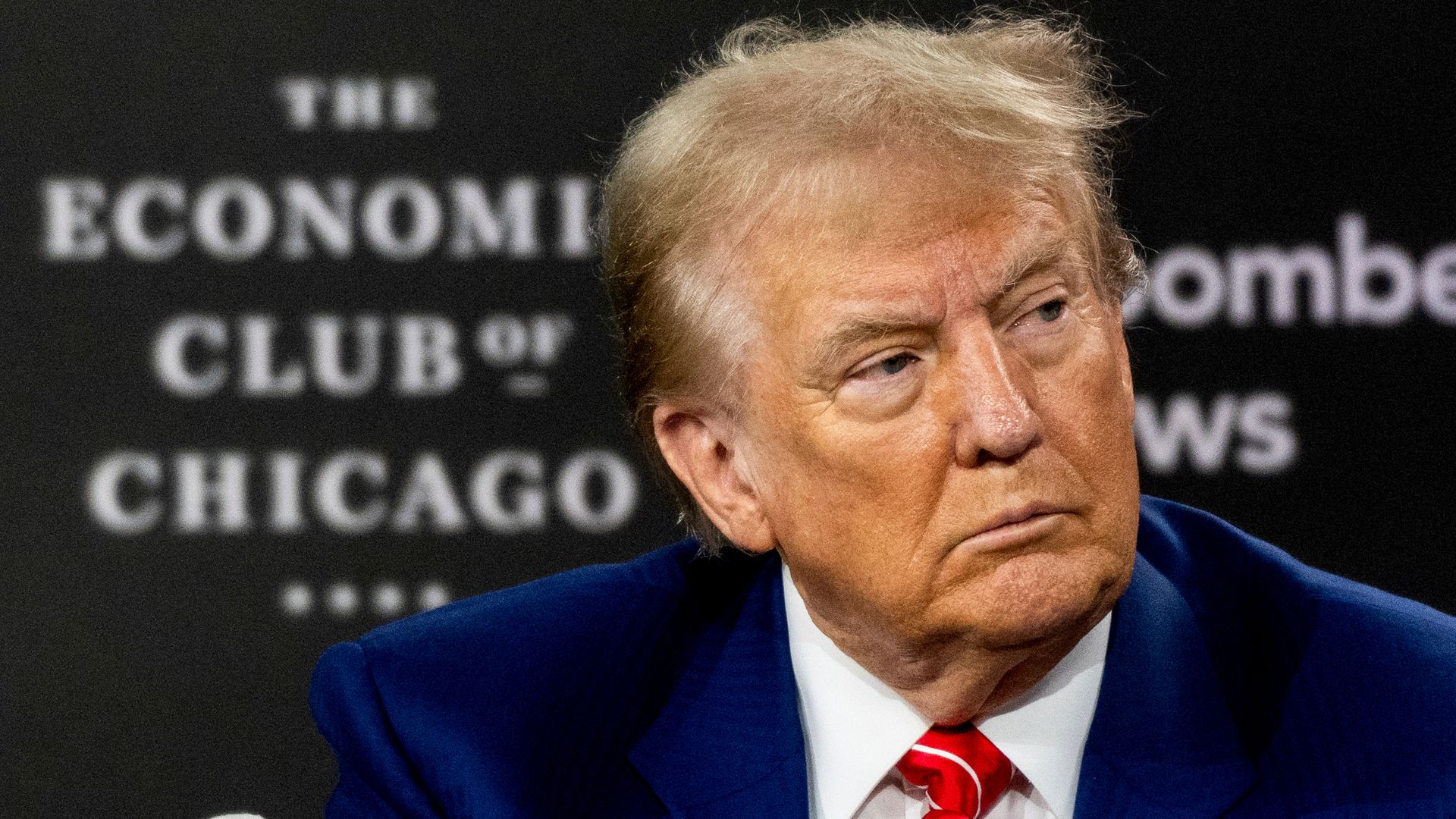 Donald Trump in front of a sign that reads The Economic Club of Chicago.