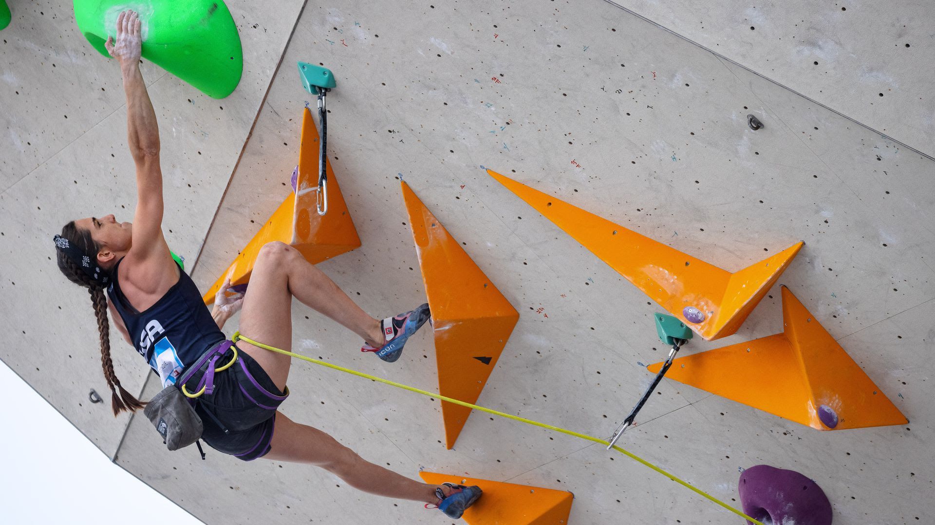 Olympic athlete Kyra Condie climbs an indoor rock climbing wall.
