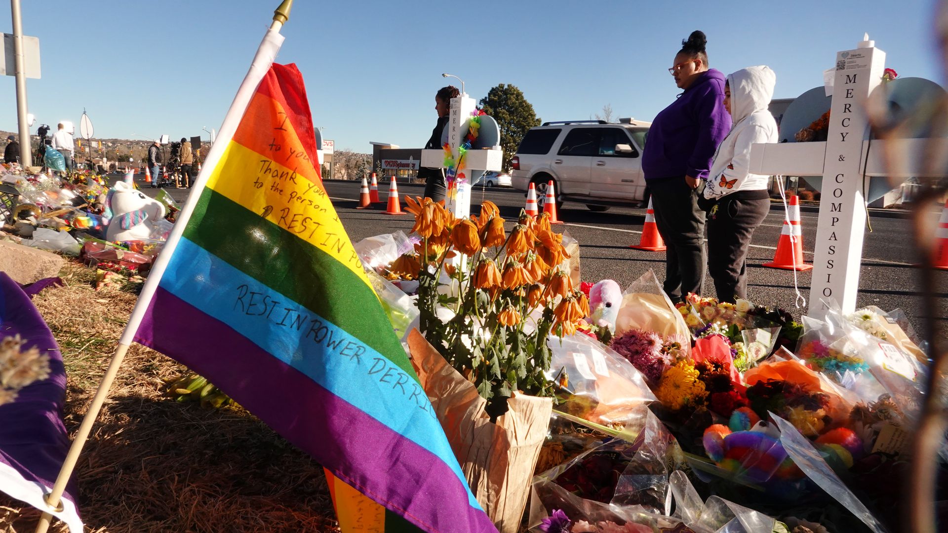 People visit a makeshift memorial near the Club Q nightclub on November 22, 2022 in Colorado Springs, Colorado. 