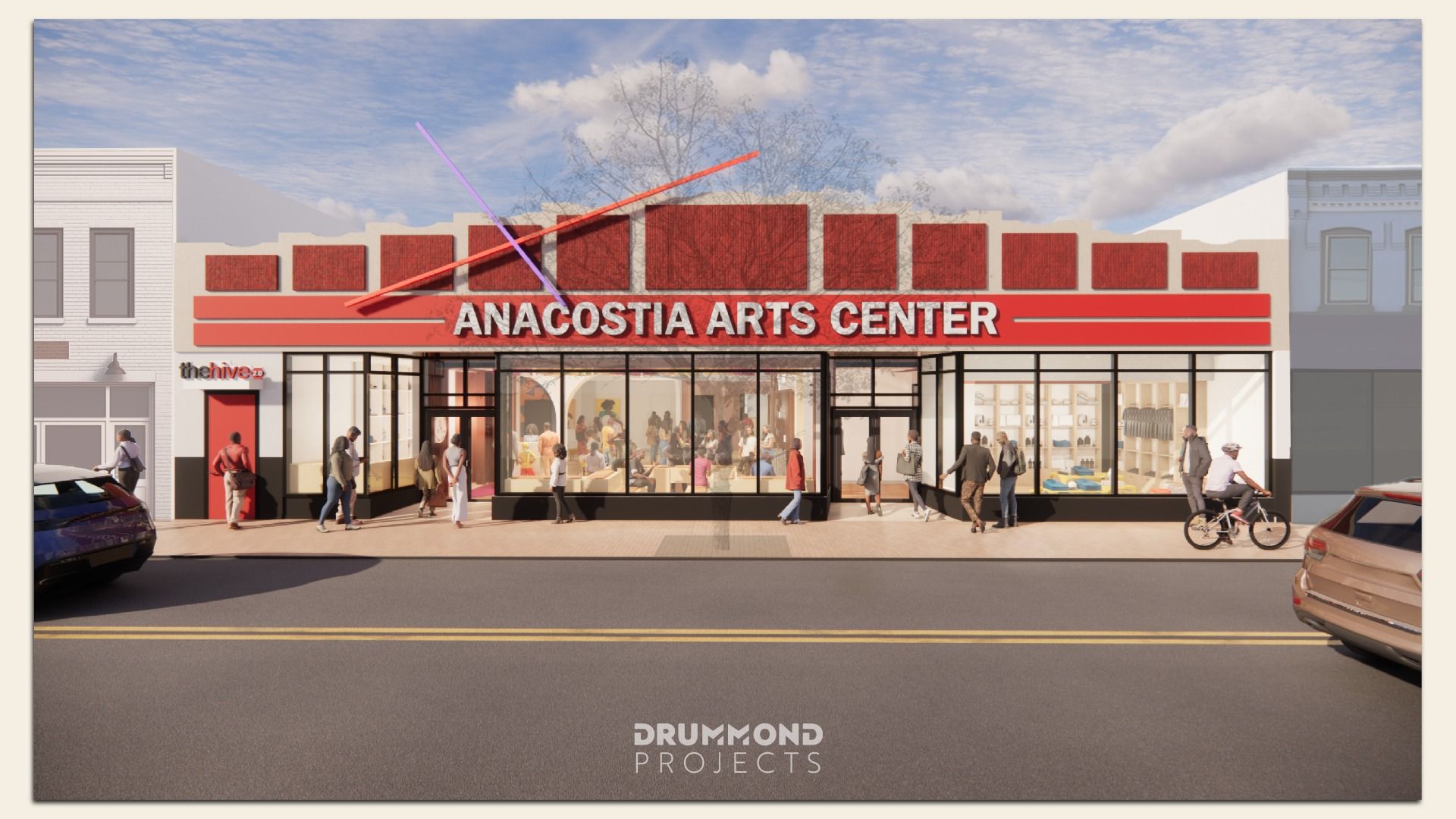 Front view of the Anacostia Arts Center with large glass windows showing people inside, a red facade with white lettering, and people walking and biking on the sidewalk outside.