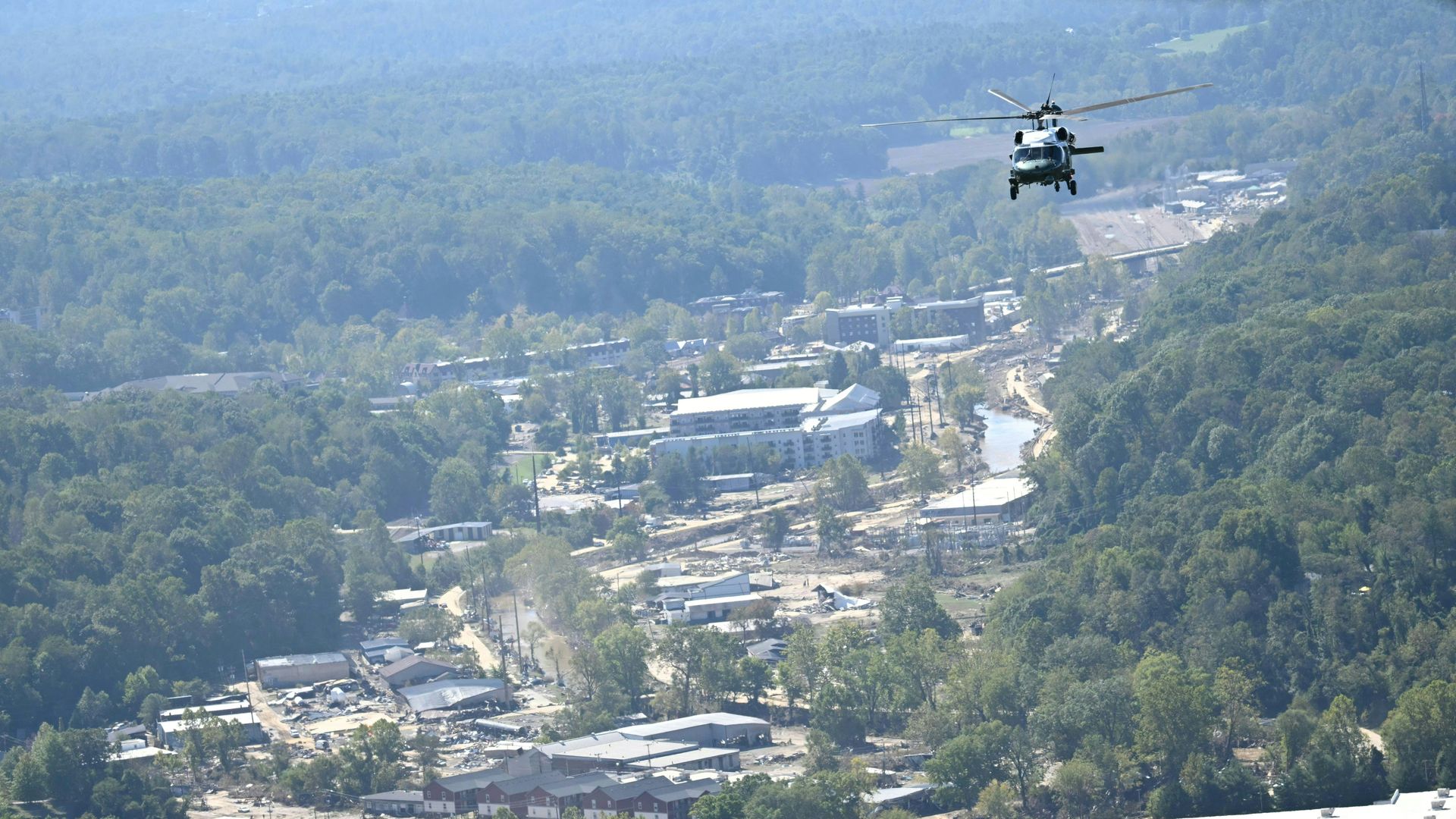 Marine One, carrying US President Joe Biden flies over the flood-hit city of Asheville, South Carolina on October 2, 2024. Biden is visiting North and South Carolina to survey the damage after the passage of Hurricane Helene. (Photo by Mandel NGAN / AFP) (Photo by MANDEL NGAN/AFP via Getty Images)