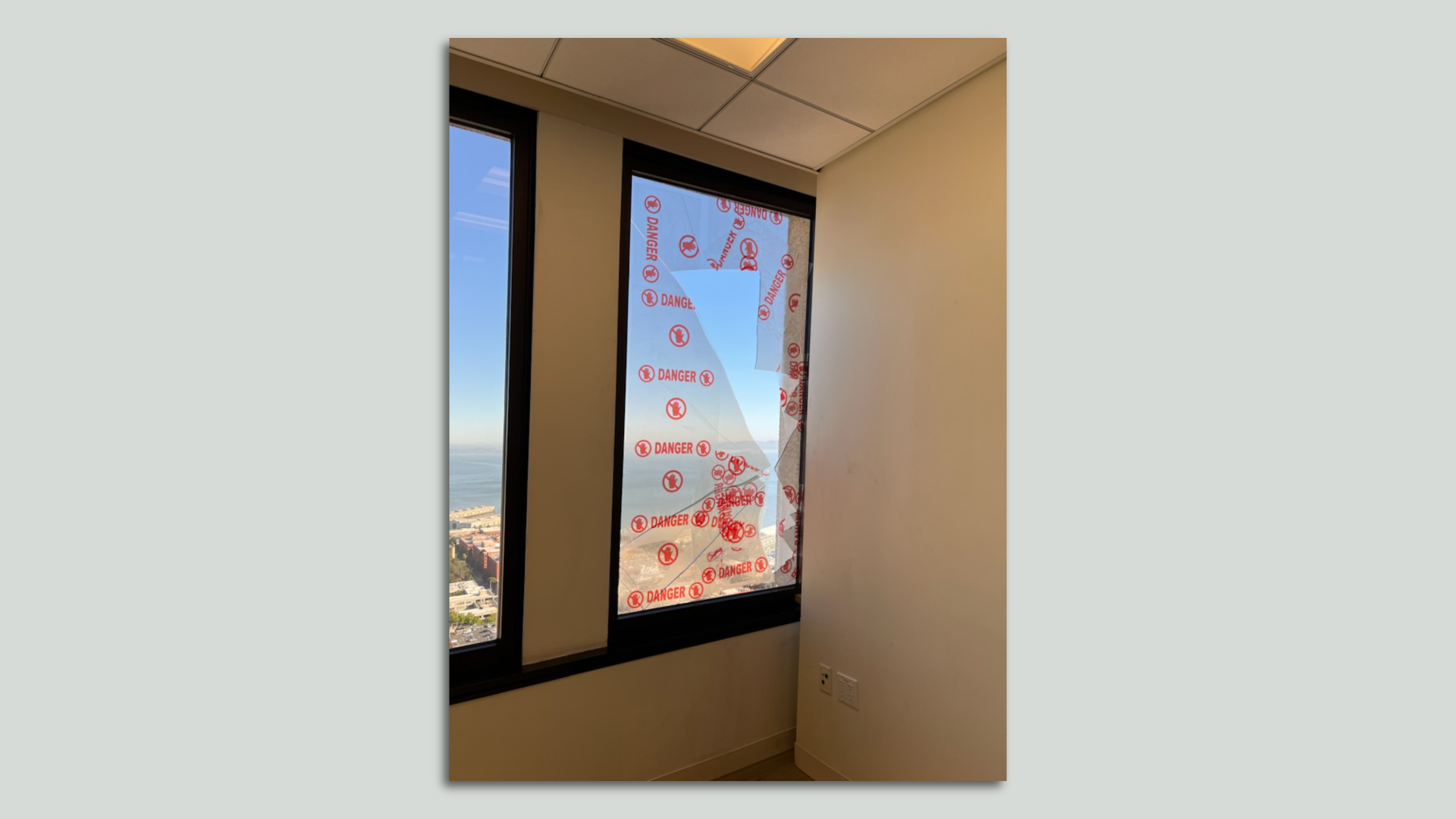 Photo of a broken window pane looking out into San Francisco