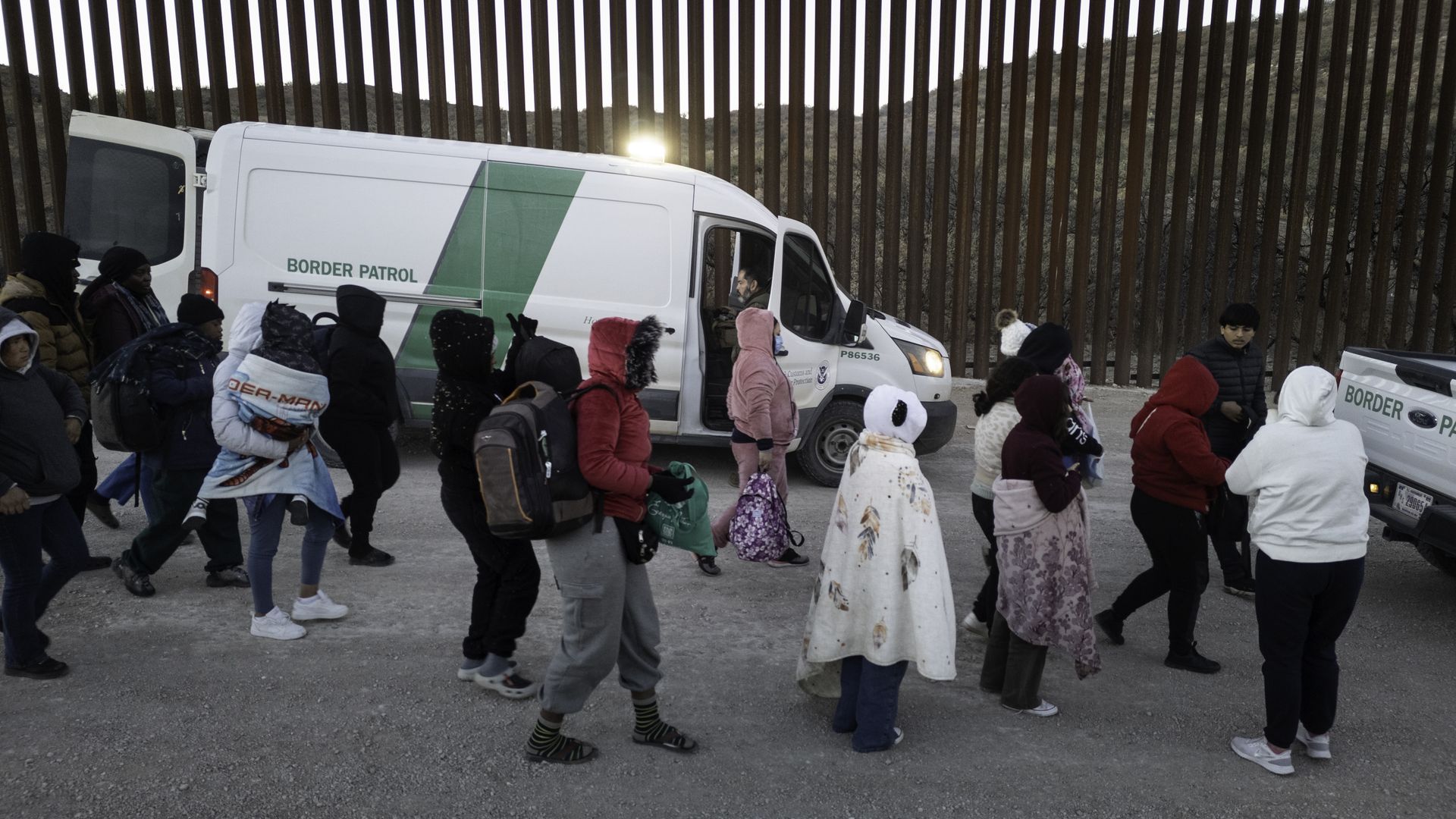 Immigrants prepare to be transported by U.S. Border Patrol agents after crossing the U.S.-Mexico border on January 20, 2025 near Sasabe, Arizona. Immigrant families had passed through a gap in the Trump-built border wall hours before Donald J. Trump was inaugurated for a second time as President of 